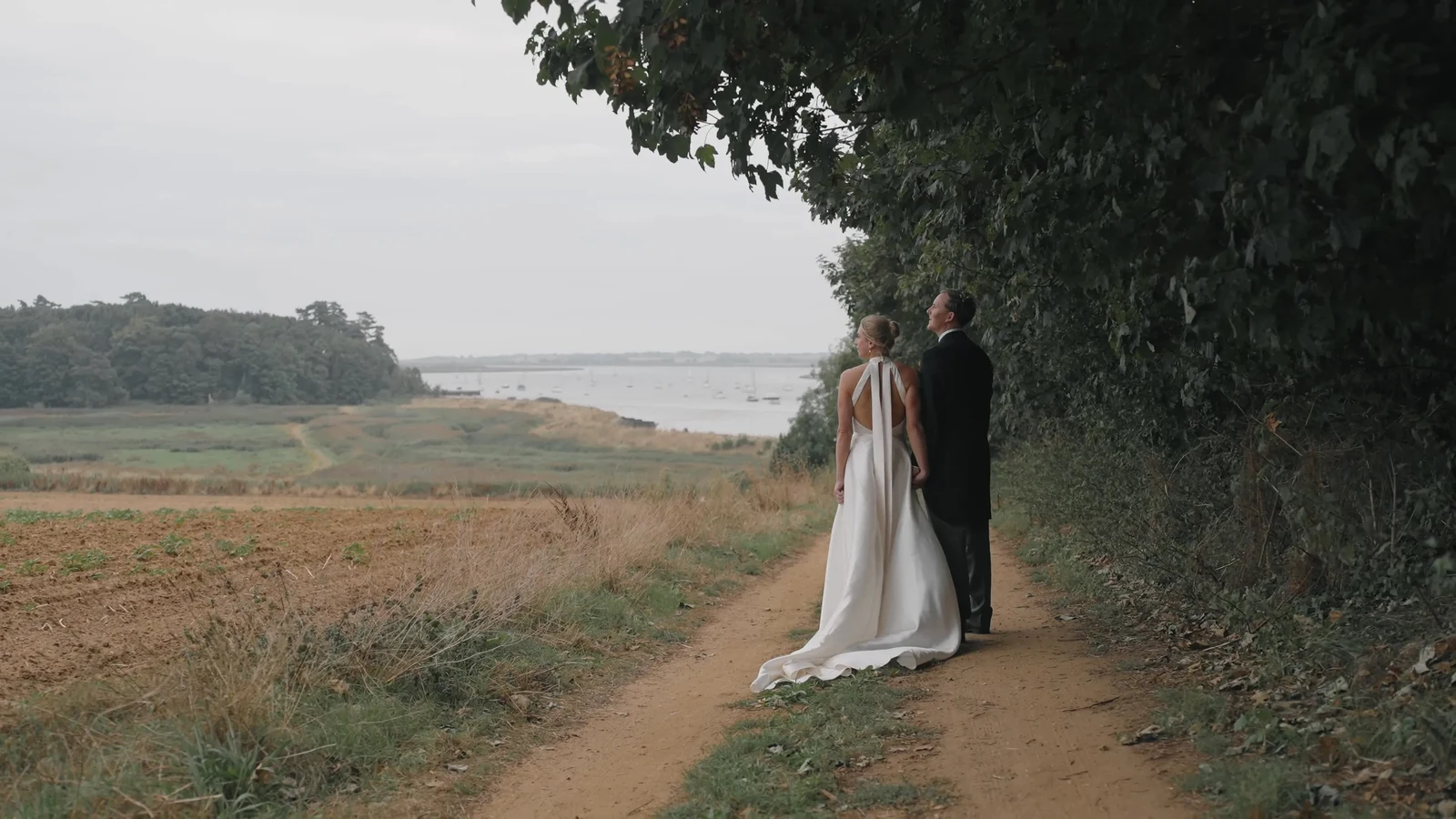 Film still: Harriet and Luke together beneath the trees