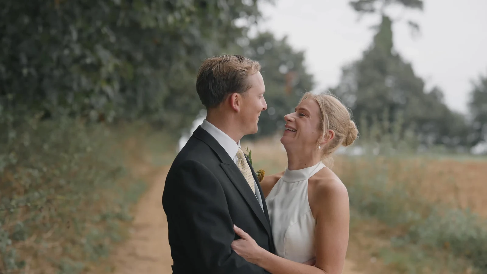 Film still: Harriet and Luke smiling at one another