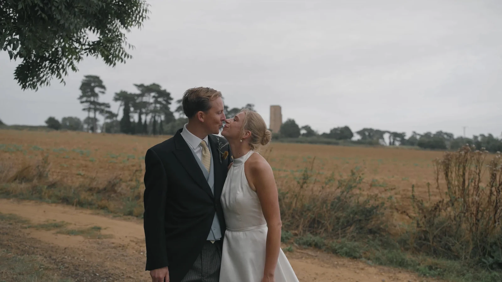 Film still: Harriet and Luke kissing in the Suffolk countryside