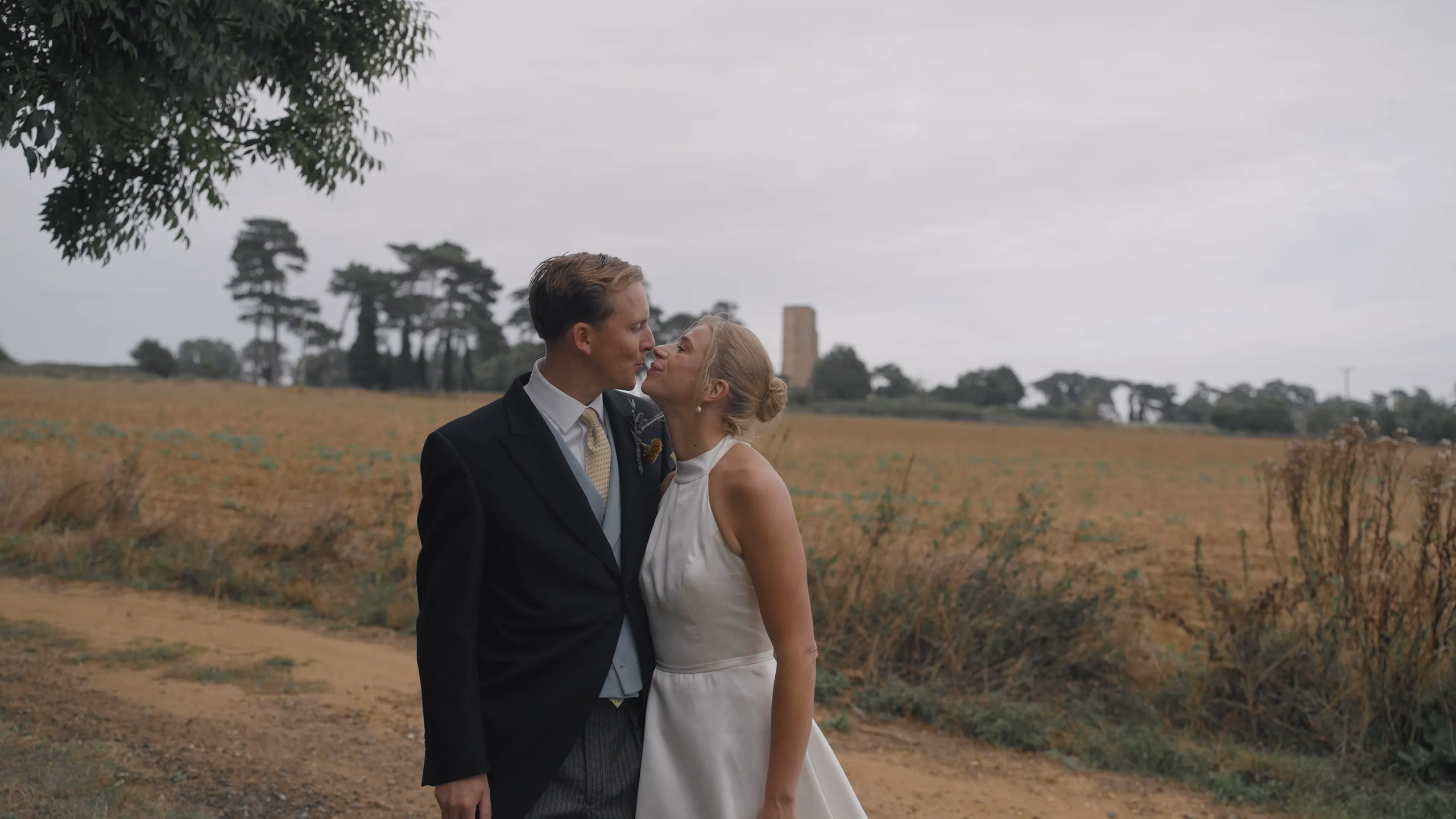 Film still: Harriet and Luke kissing in the Suffolk countryside