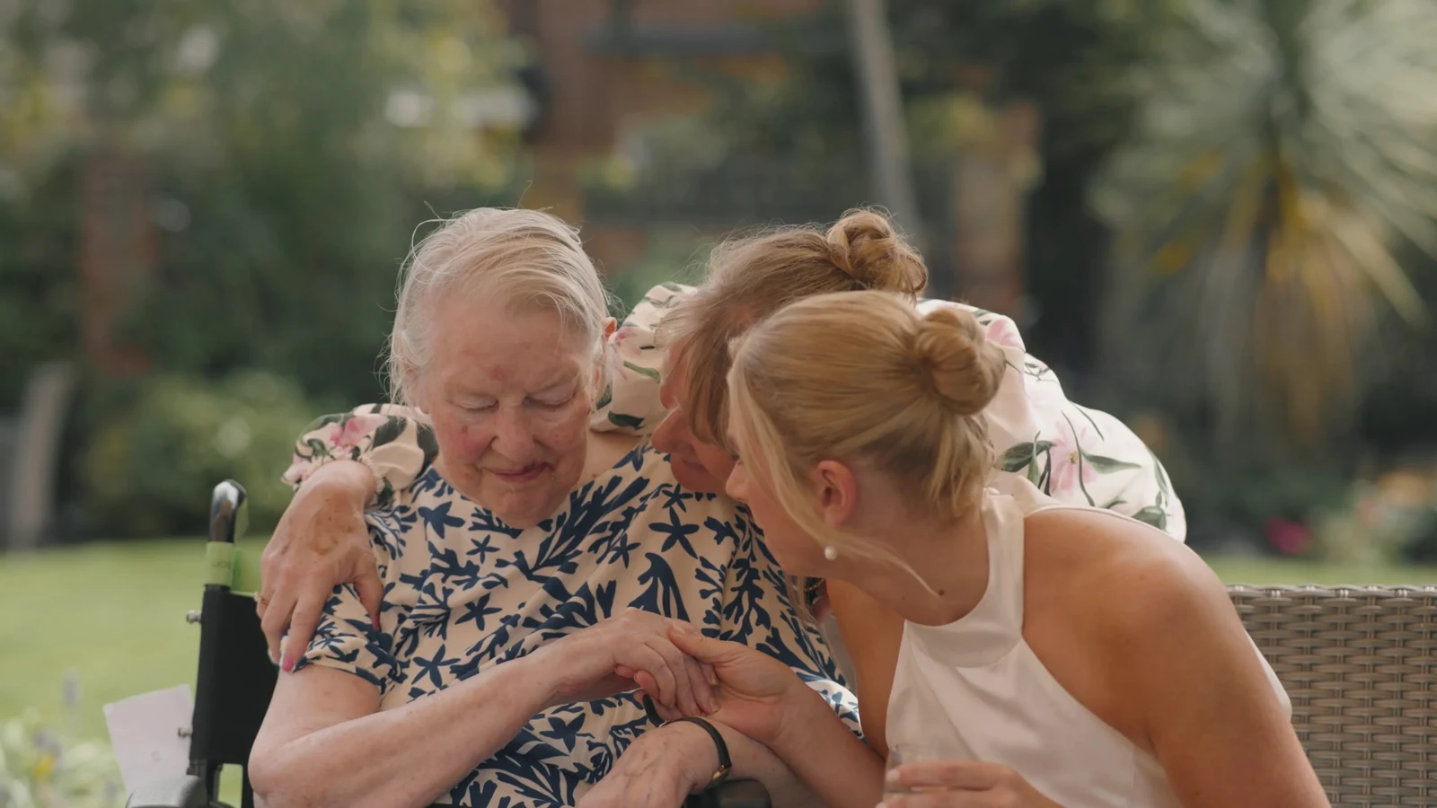 Film still: Harriet sharing a moment with a seated guest