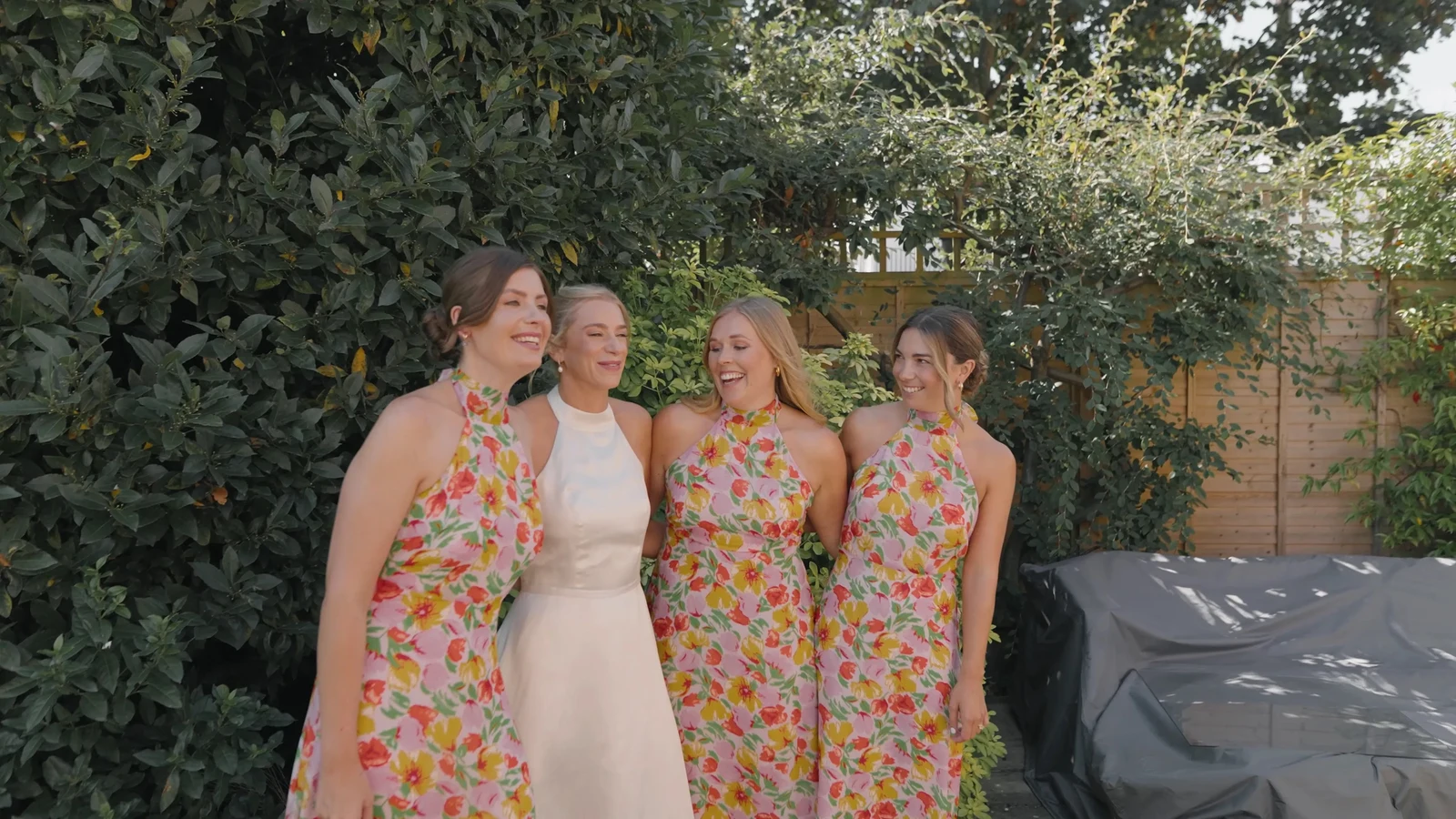 Film still: Bridesmaids together in the garden