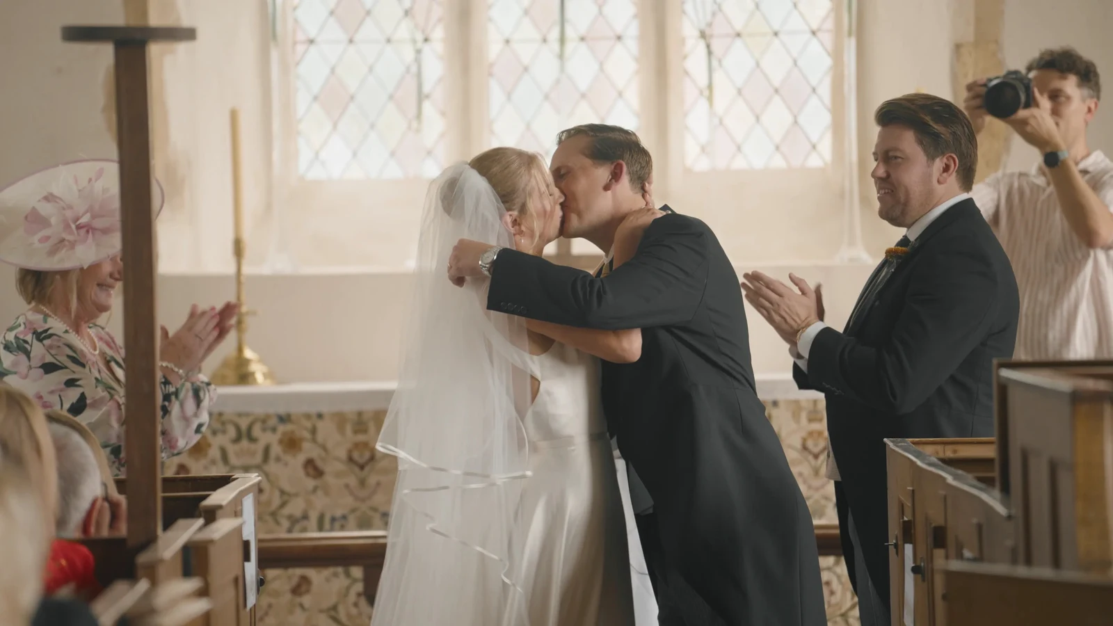 Film still: Harriet and Luke kissing during their ceremony