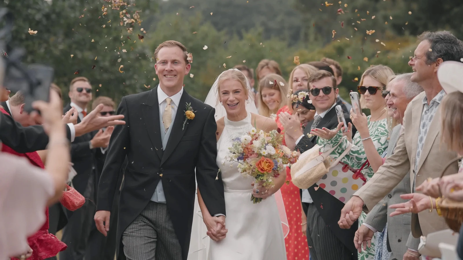 Film still: Harriet and Luke walking through confetti