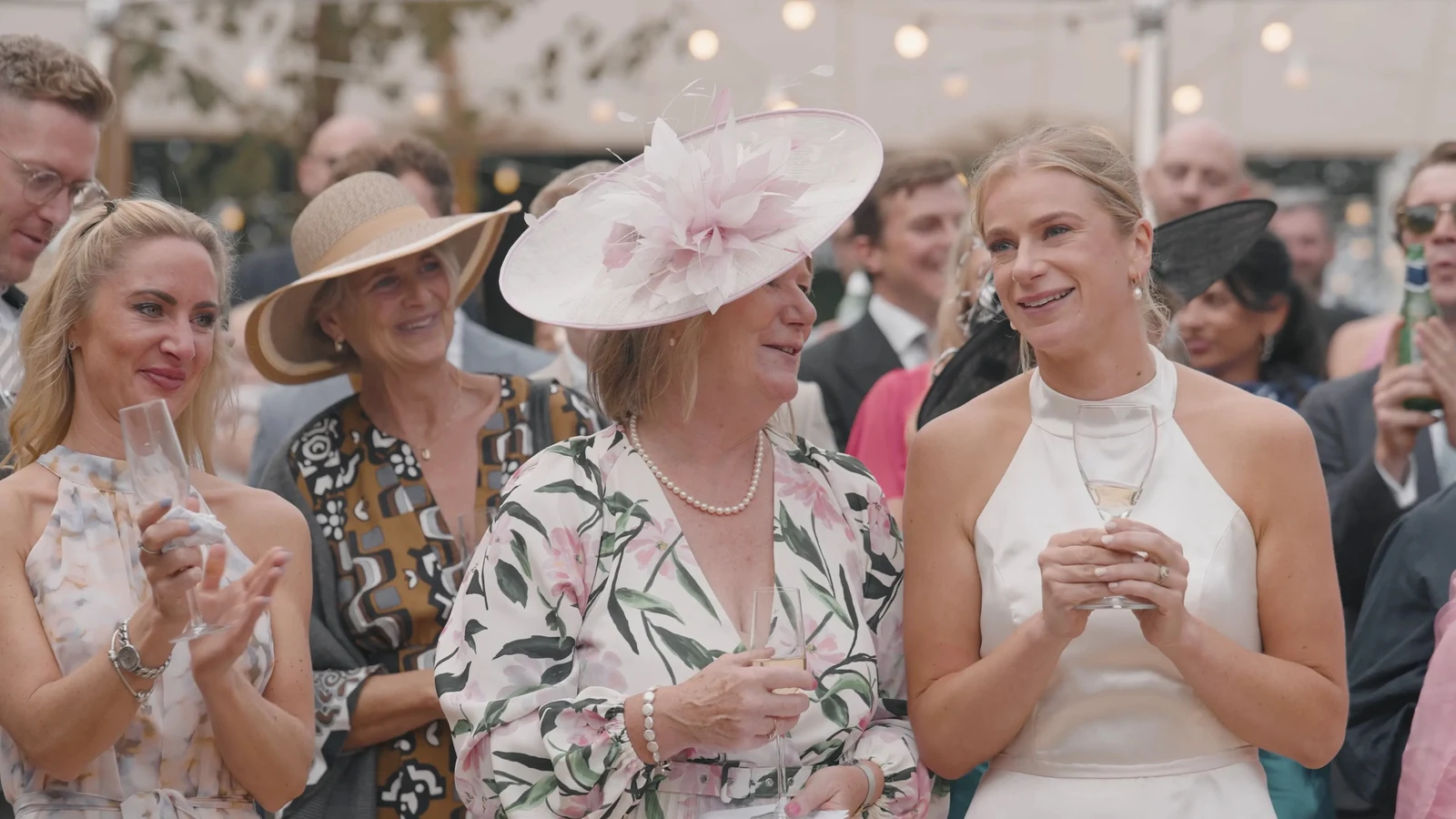 Film still: Harriet and wedding guests listening together