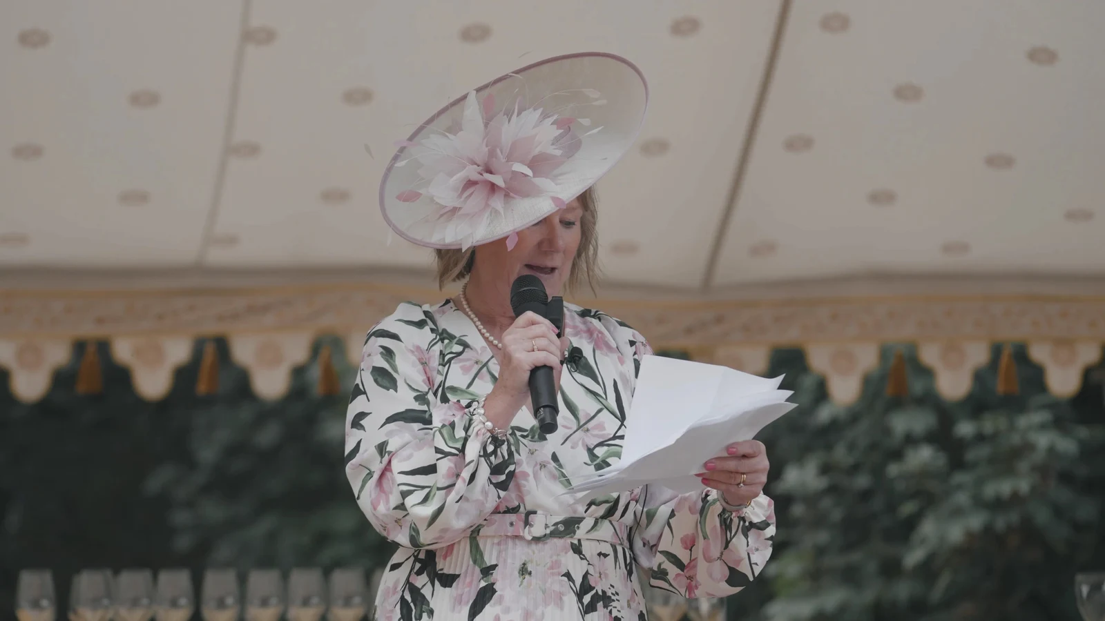 Film still: A wedding speech beneath the marquee