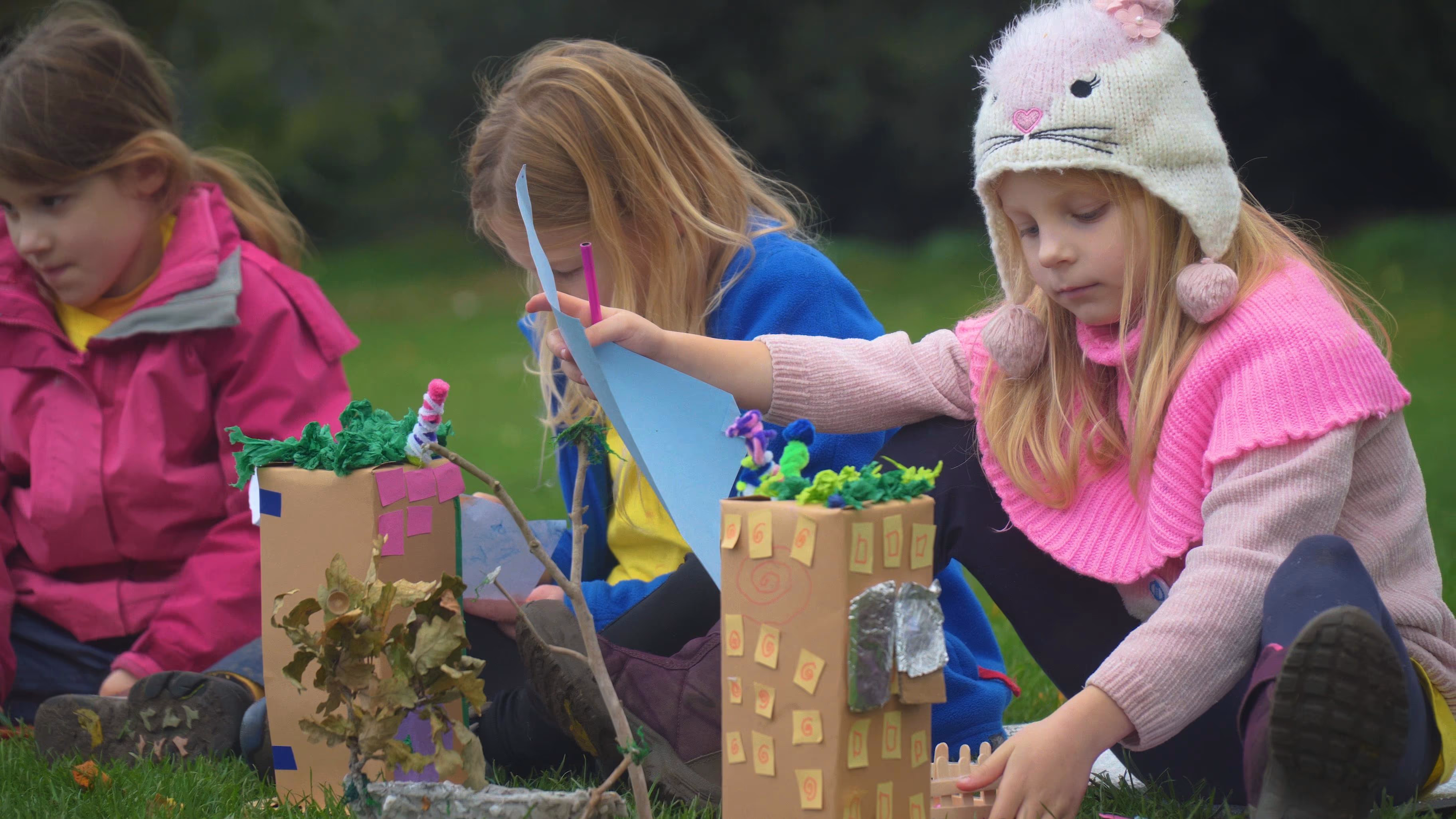 Children working together on a colourful model at The Hive