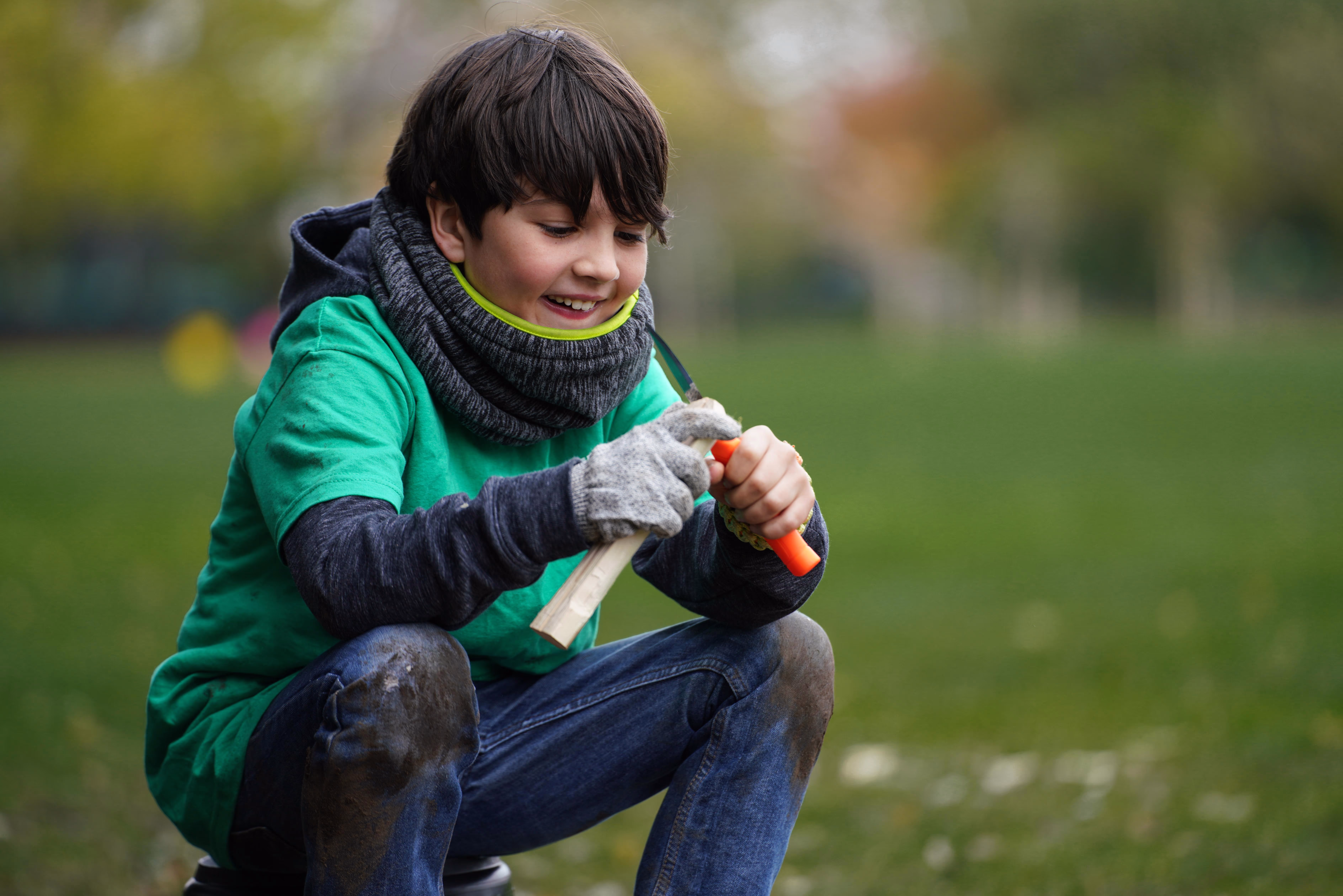 Child working carefully with a piece of wood at The Hive