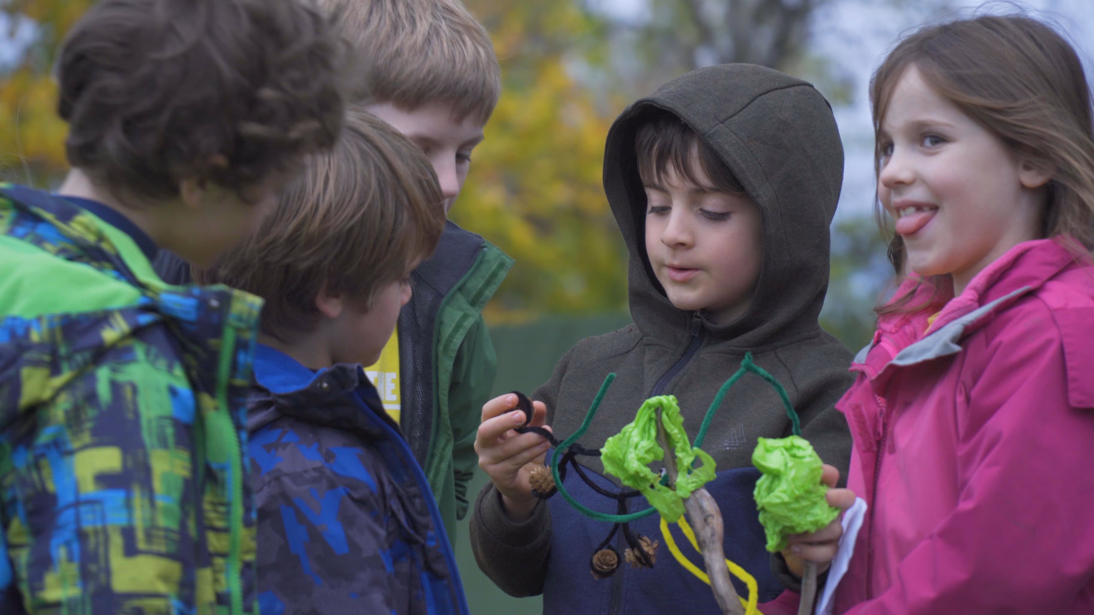 Children looking at a green model during a Hive Kids workshop