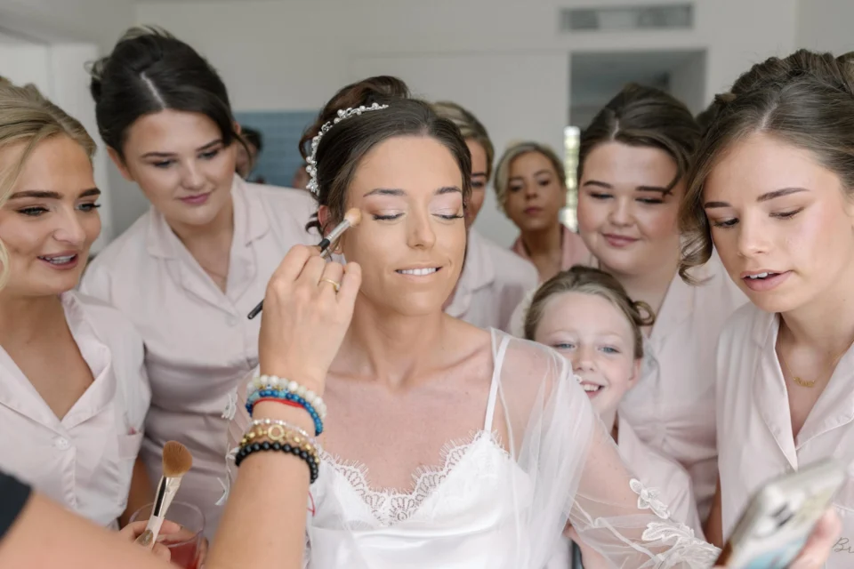 The bridal party gathered around Ellie during preparations