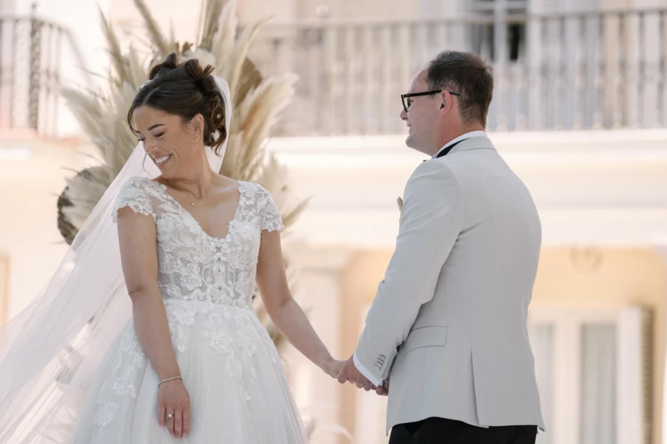 Ellie and Ernie holding hands during the ceremony