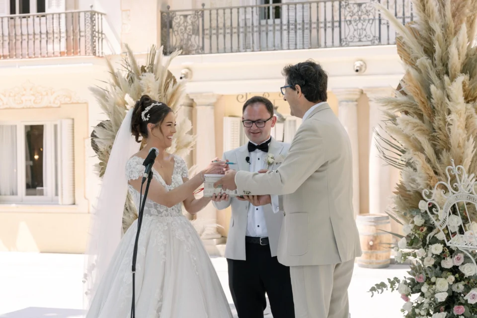 Ellie and Ernie exchanging vows beneath the trees