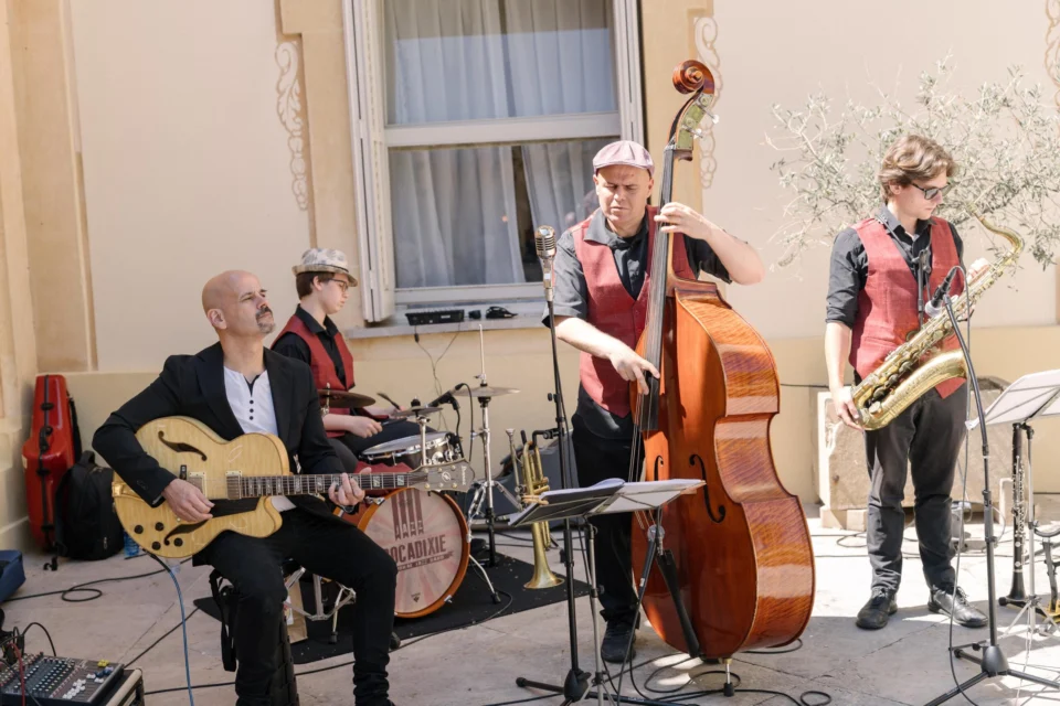 Musicians playing guitar, double bass and saxophone at the wedding