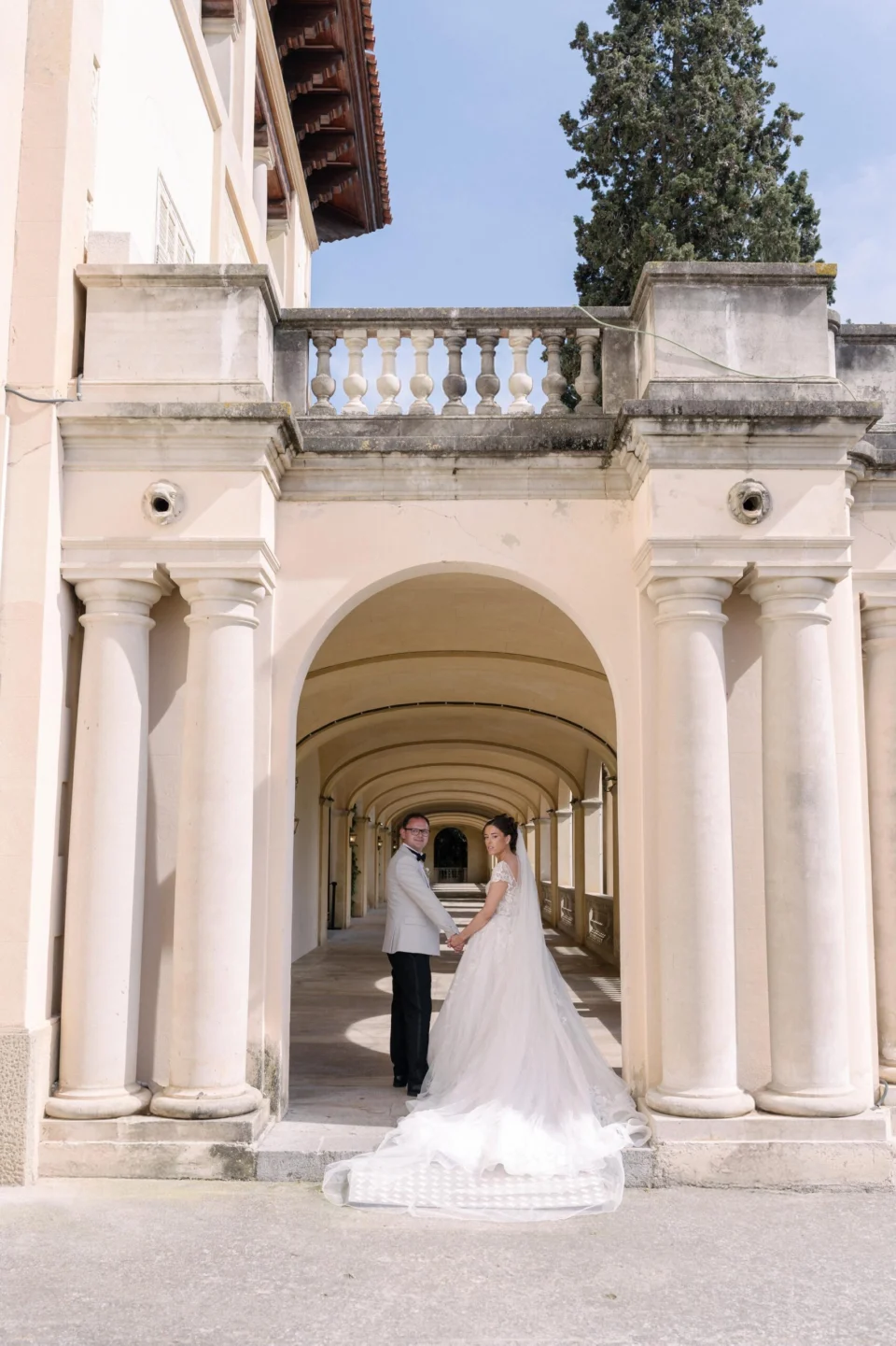 Ellie and Ernie beneath the tall arches of the mansion