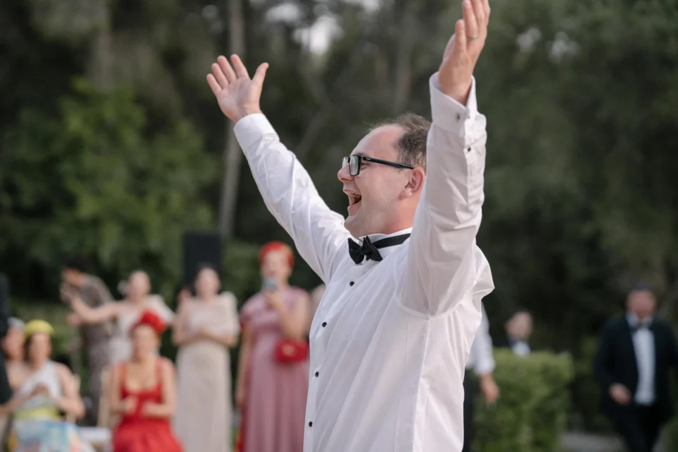 Ernie raising his arms during the wedding celebrations