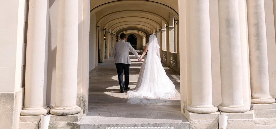 Ellie and Ernie walking through the colonnade at Finca Mas Solers