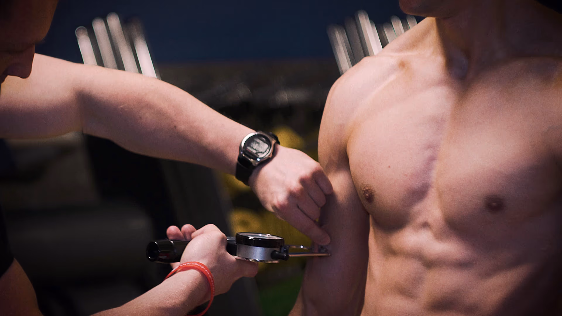 Personal trainer carrying out a body composition check