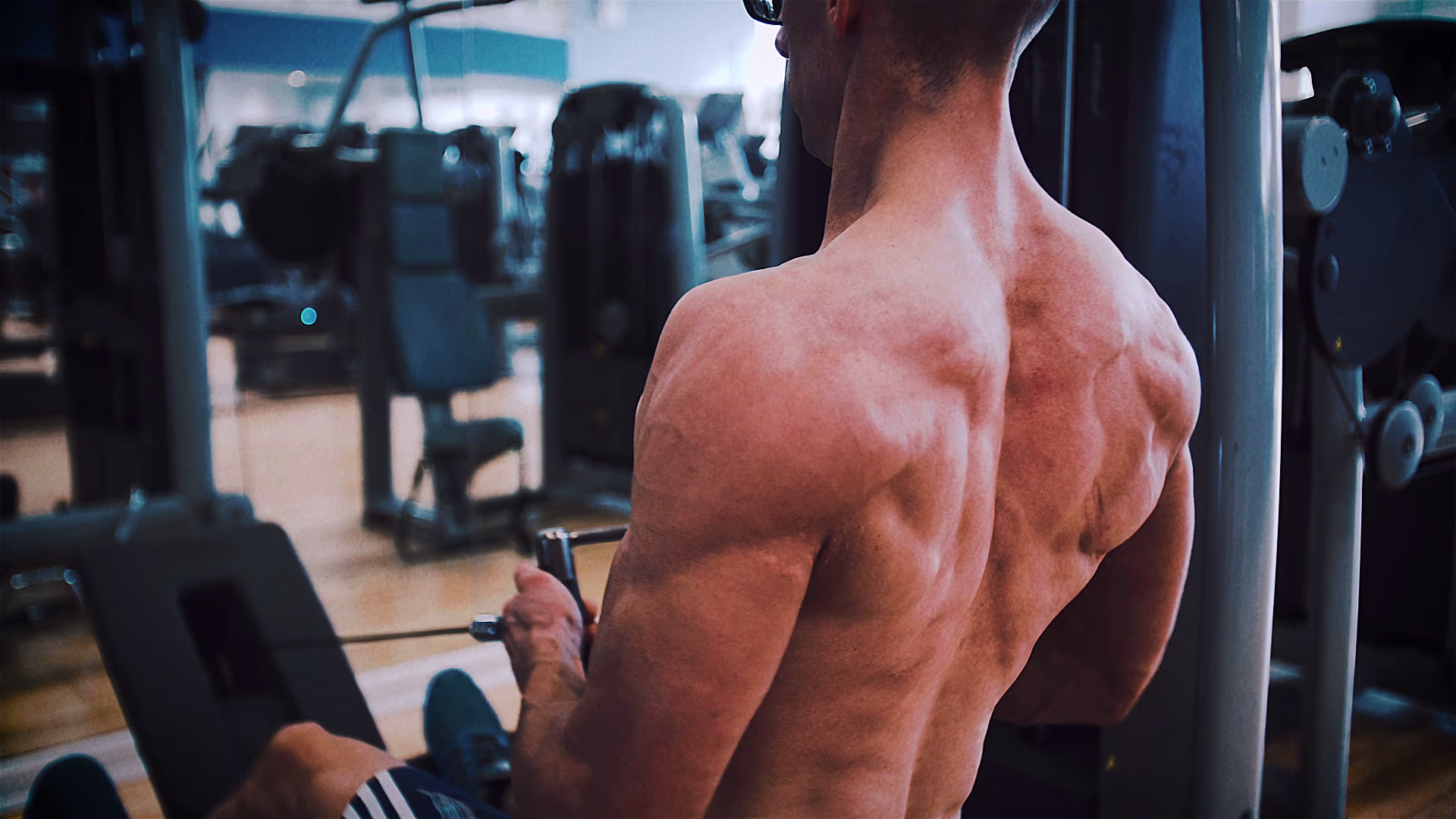 Athlete performing a cable back exercise in the gym