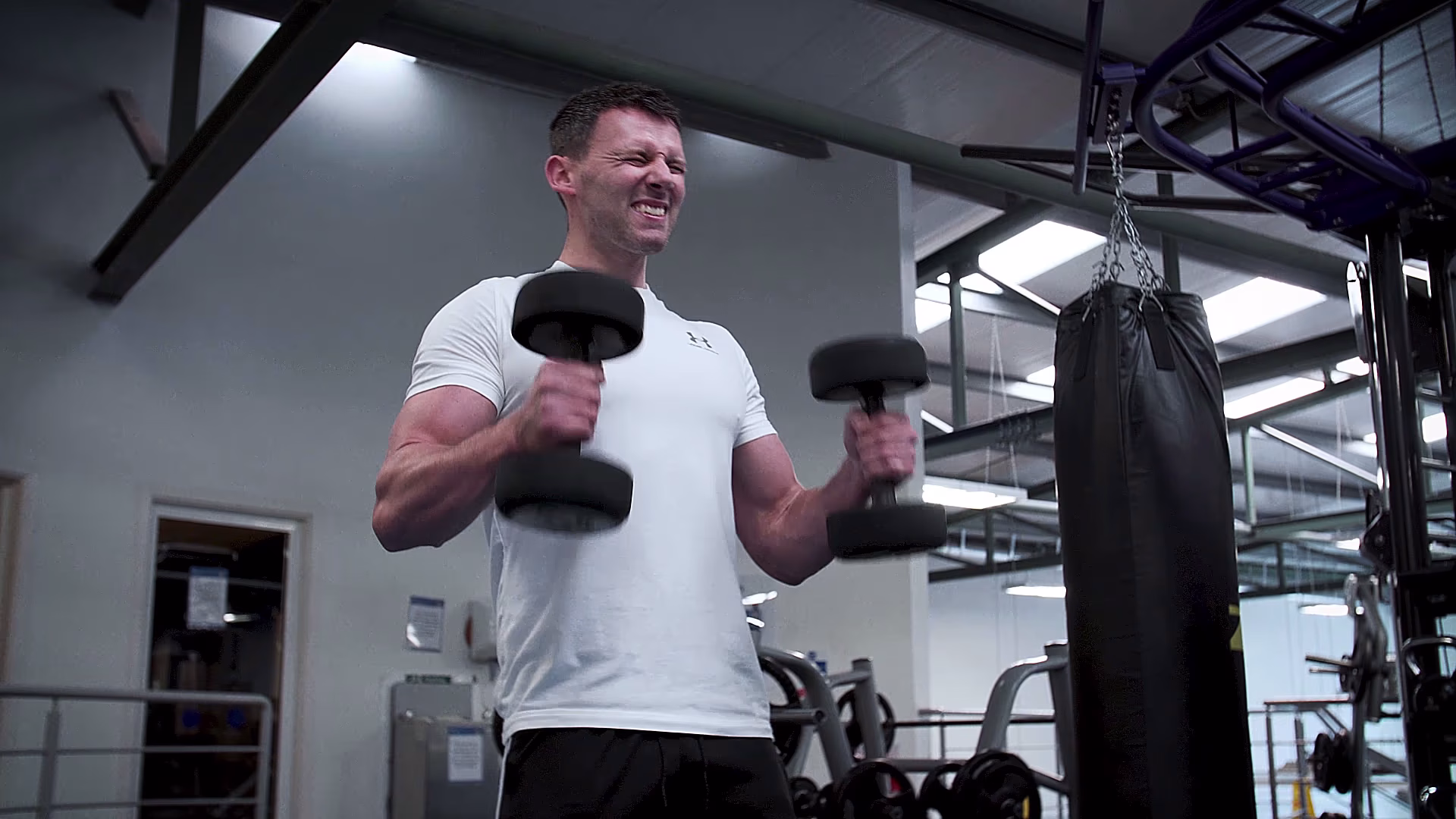 JD Fitness client performing standing dumbbell curls