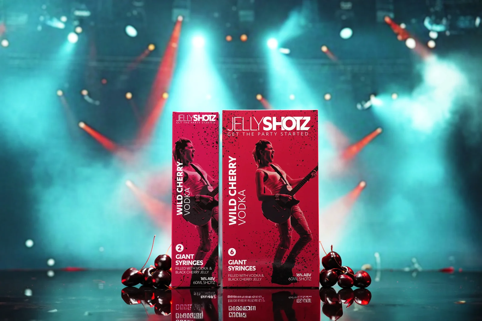 Jellyshotz Wild Cherry Vodka — two- and six-syringe packs against a stage-light backdrop