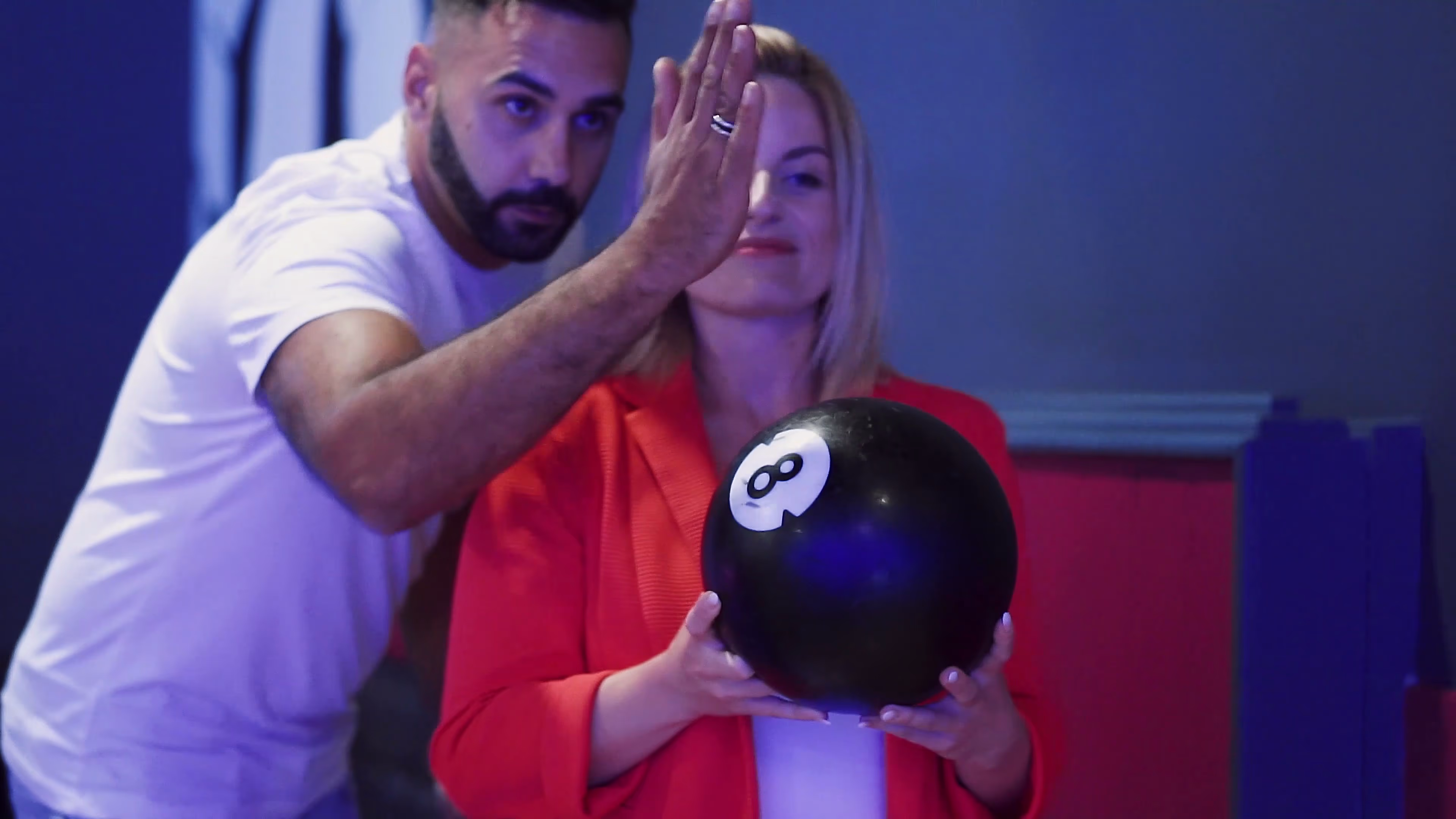 Jake and Lisa sharing a playful moment with a bowling ball