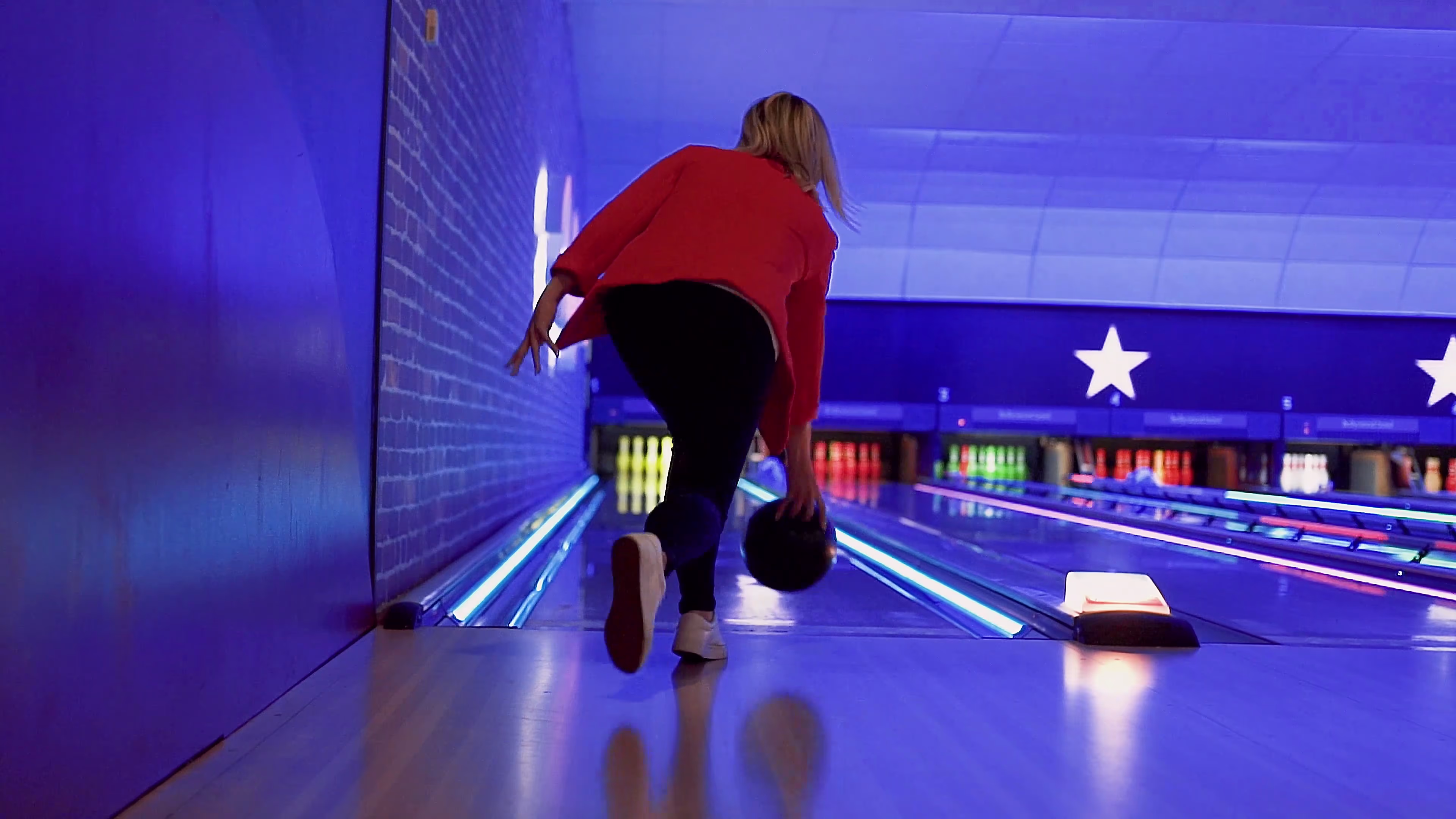 Lisa releasing the ball down the bowling lane