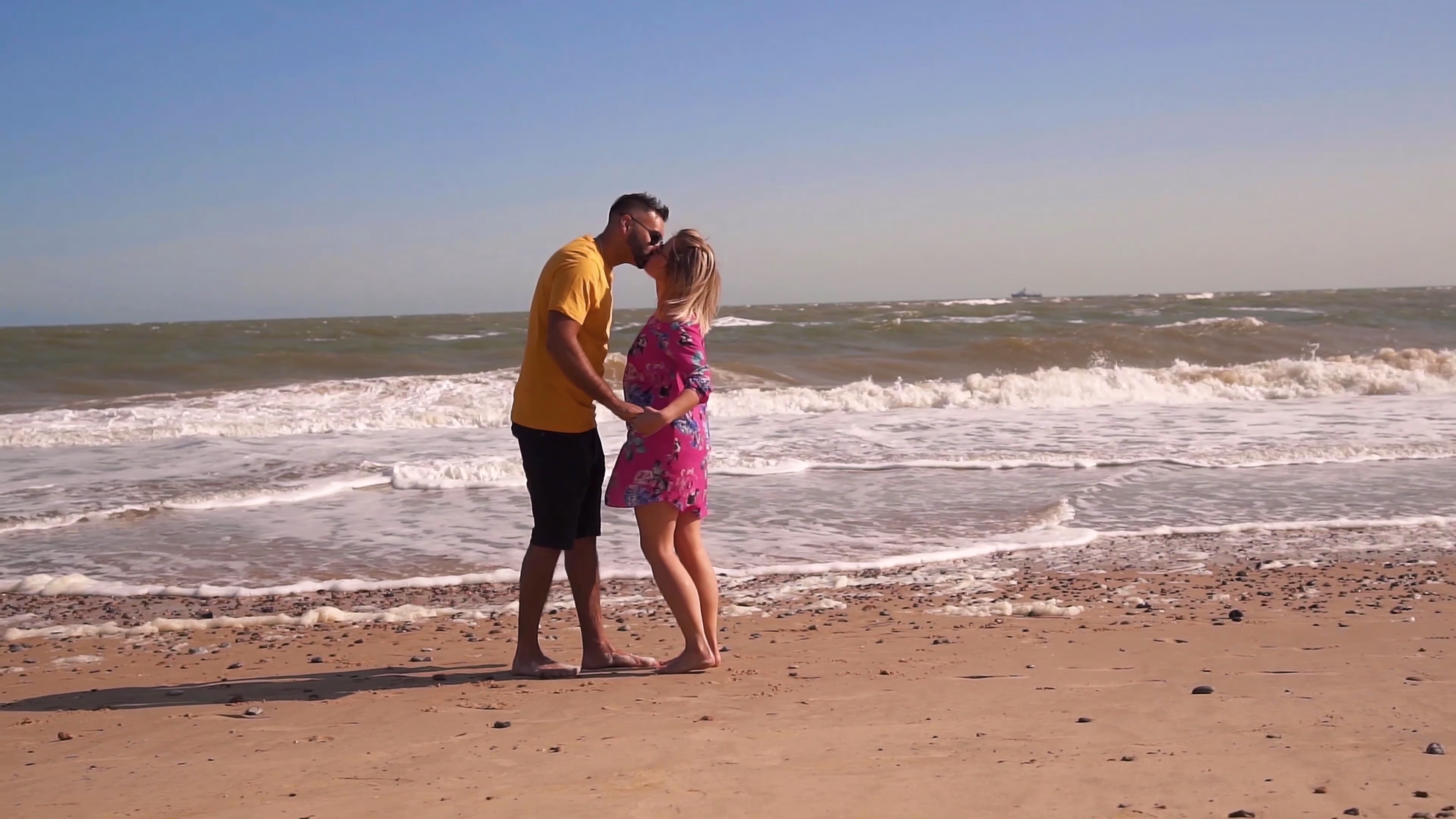 Jake and Lisa embracing on the beach