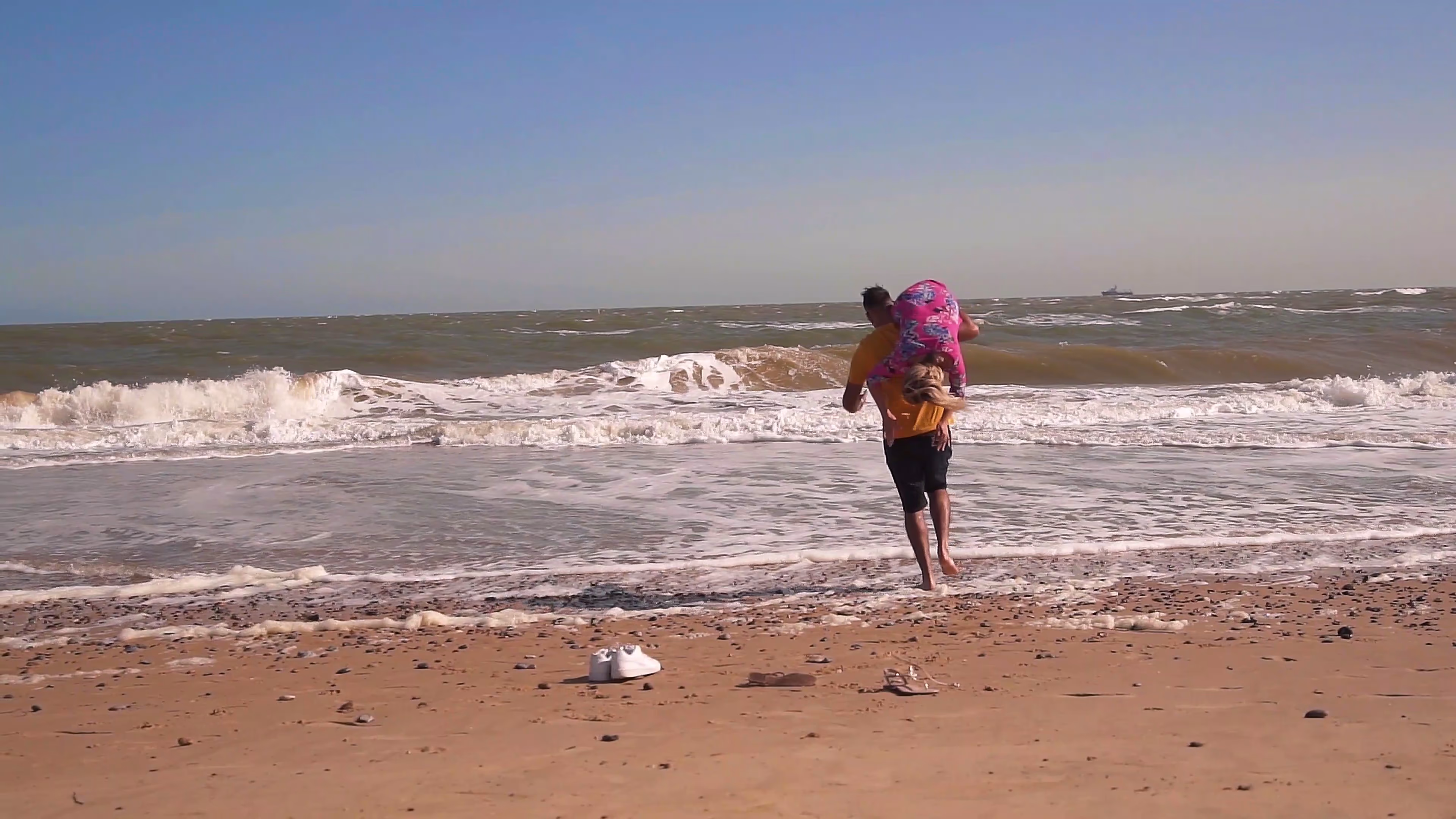 Jake and Lisa running away together along the beach