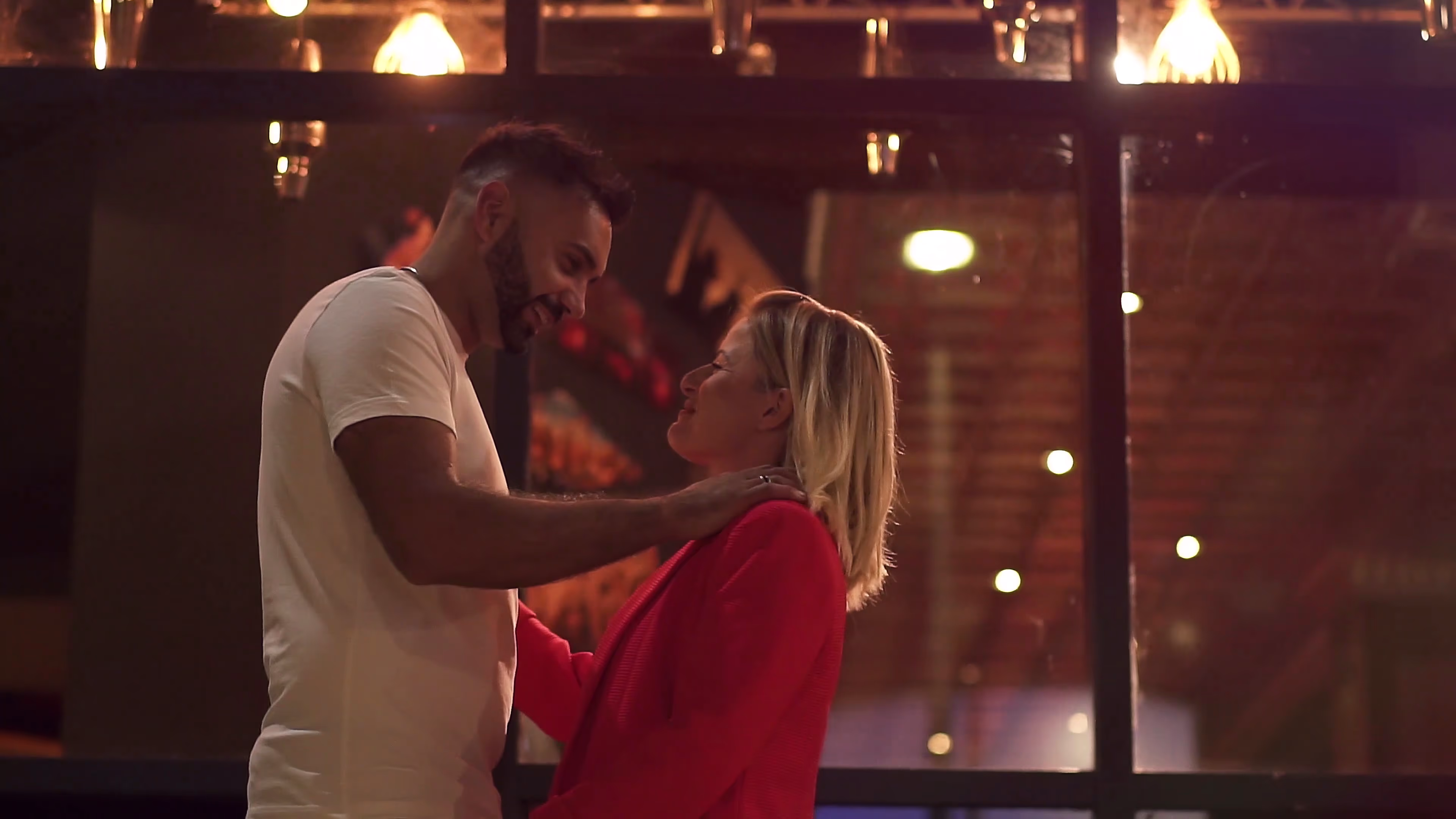 Jake and Lisa embracing during an evening date