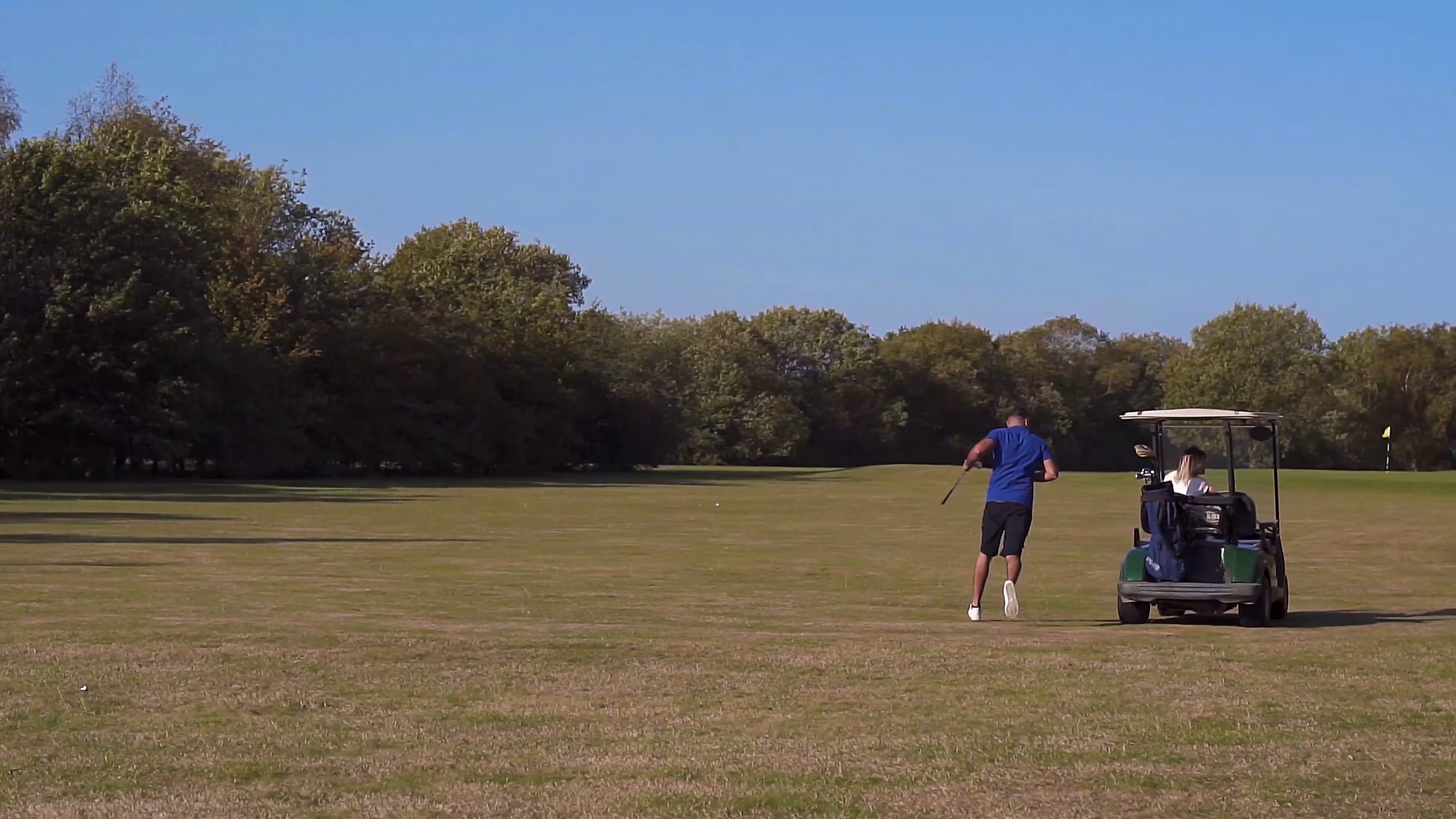 Wide view of Jake and Lisa on the golf course