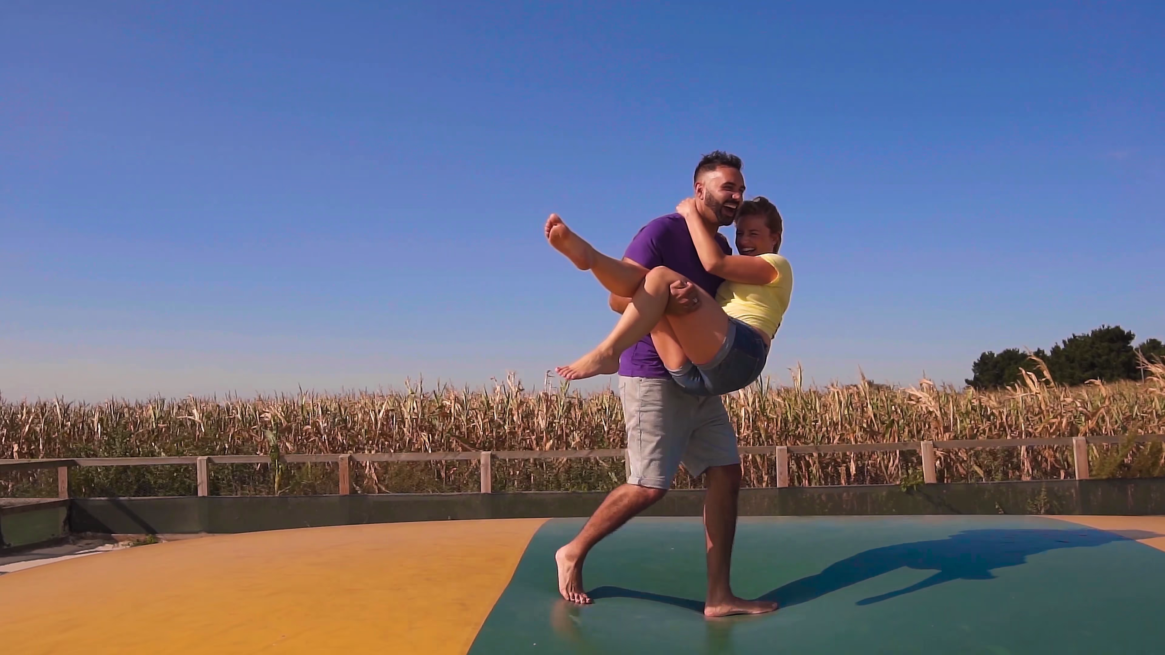 Jake lifting Lisa on the giant jumping pillow