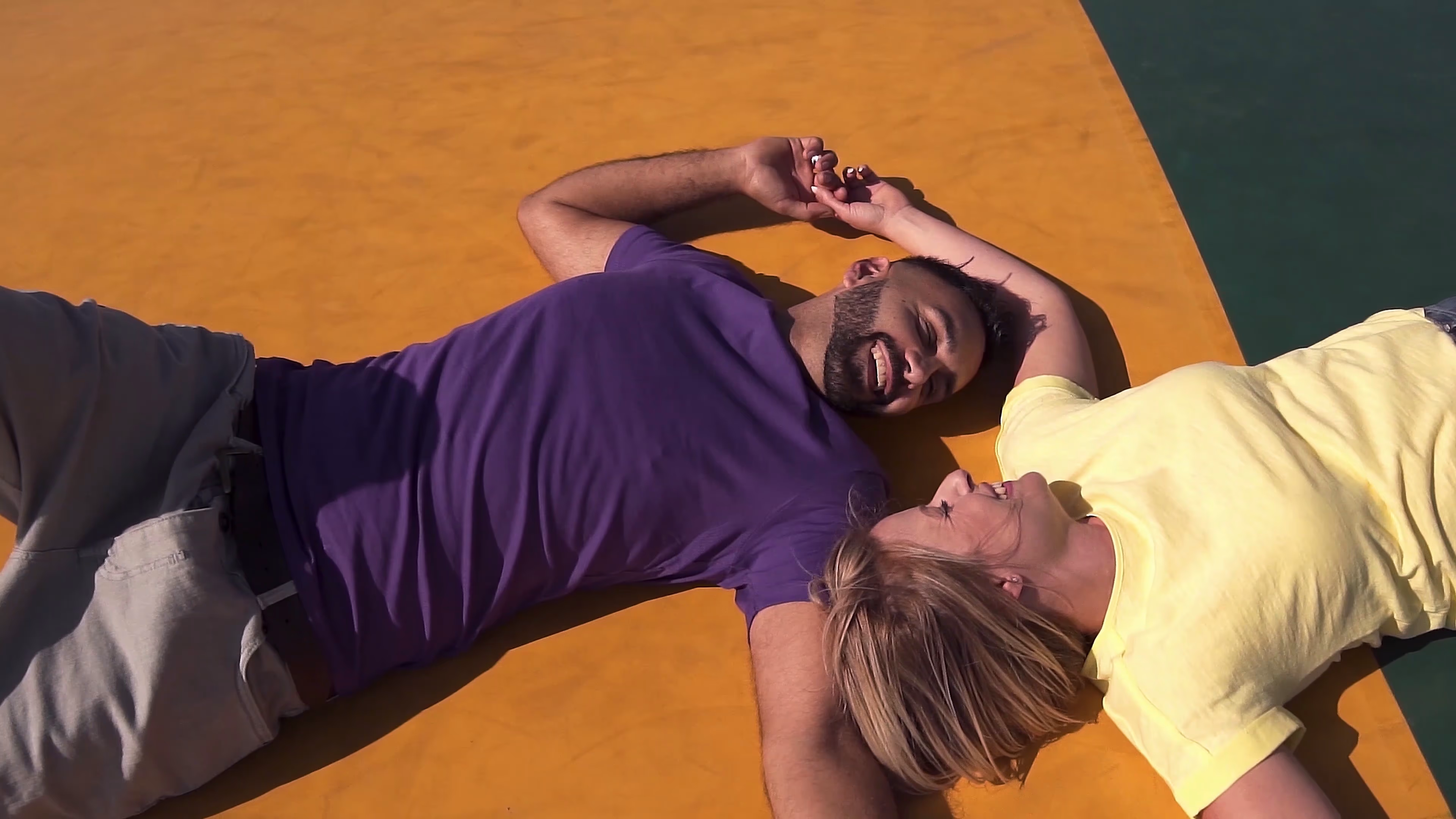 Jake and Lisa laughing on the giant jumping pillow