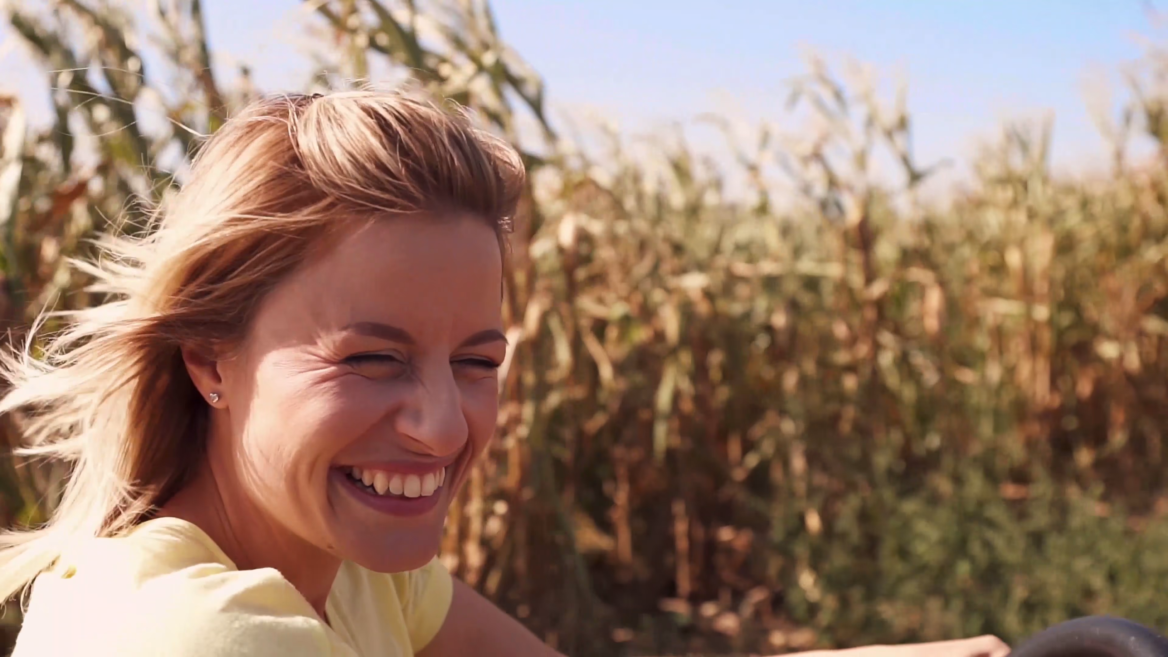 Close-up of Lisa smiling beside the maize