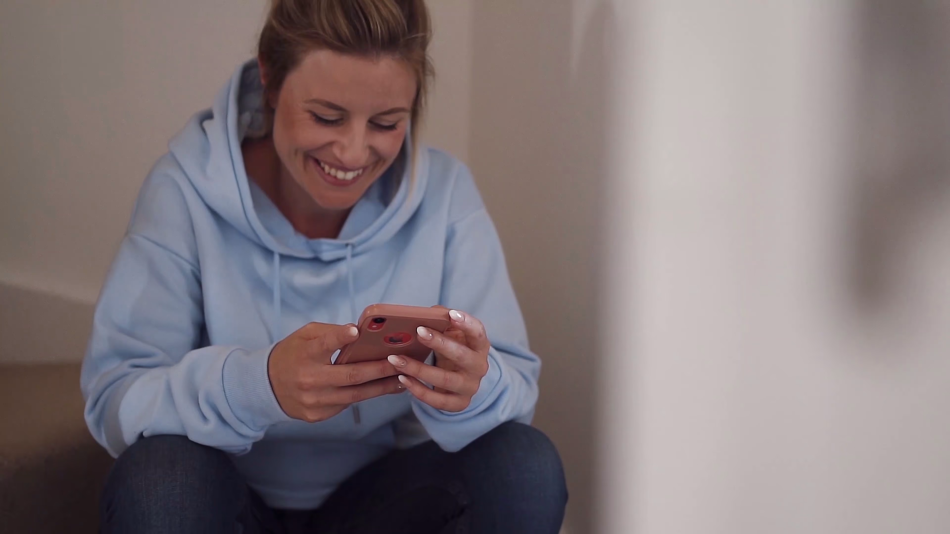 Lisa smiling while sending Jake a message