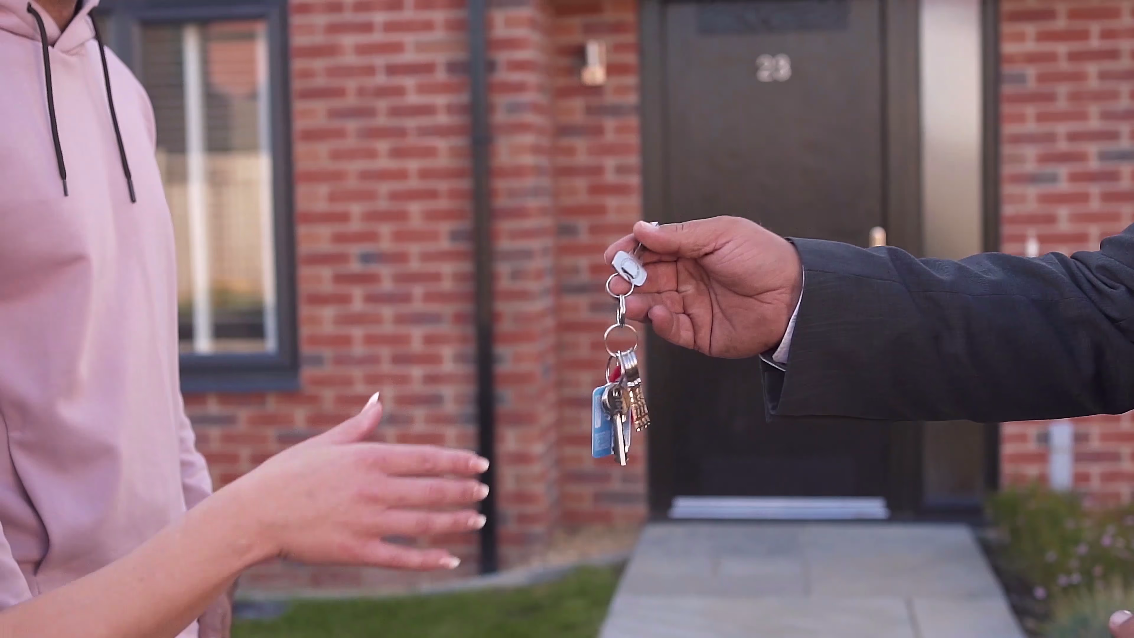 Jake holding out the key to the couple's new home