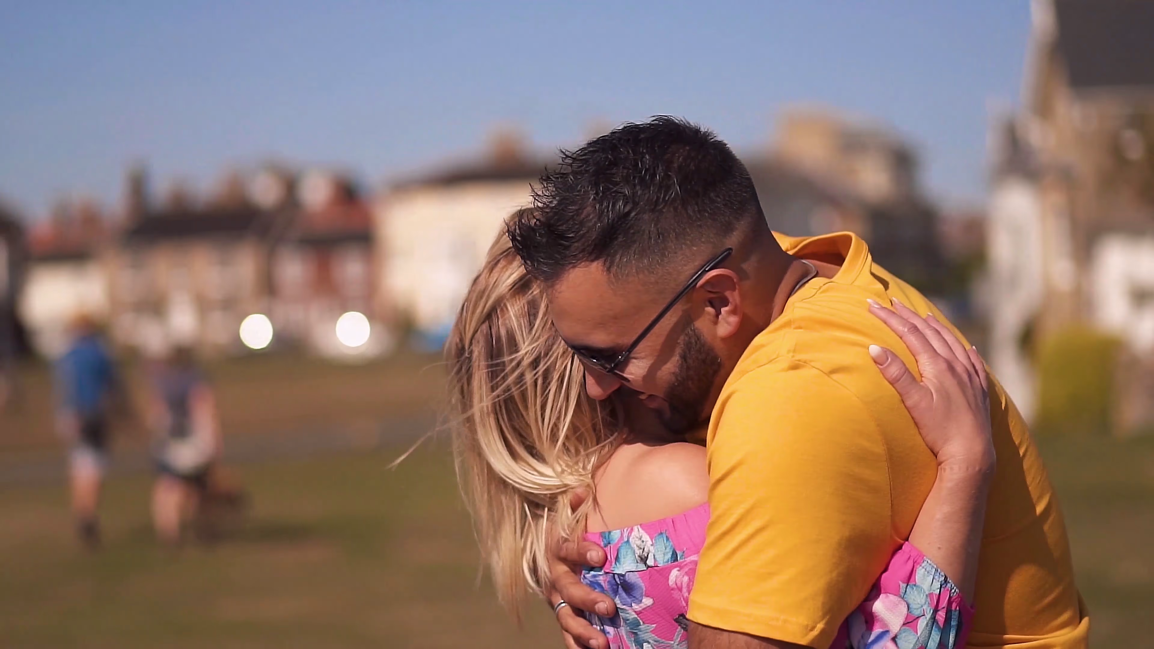 Jake and Lisa kissing beside the sea