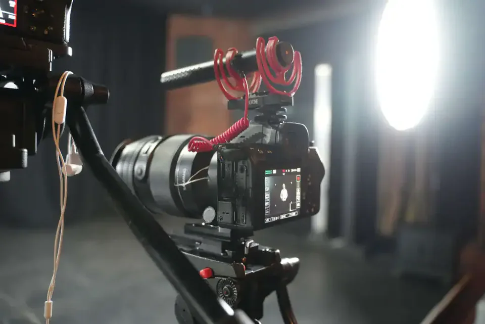 Camera with an on-camera microphone prepared for filming