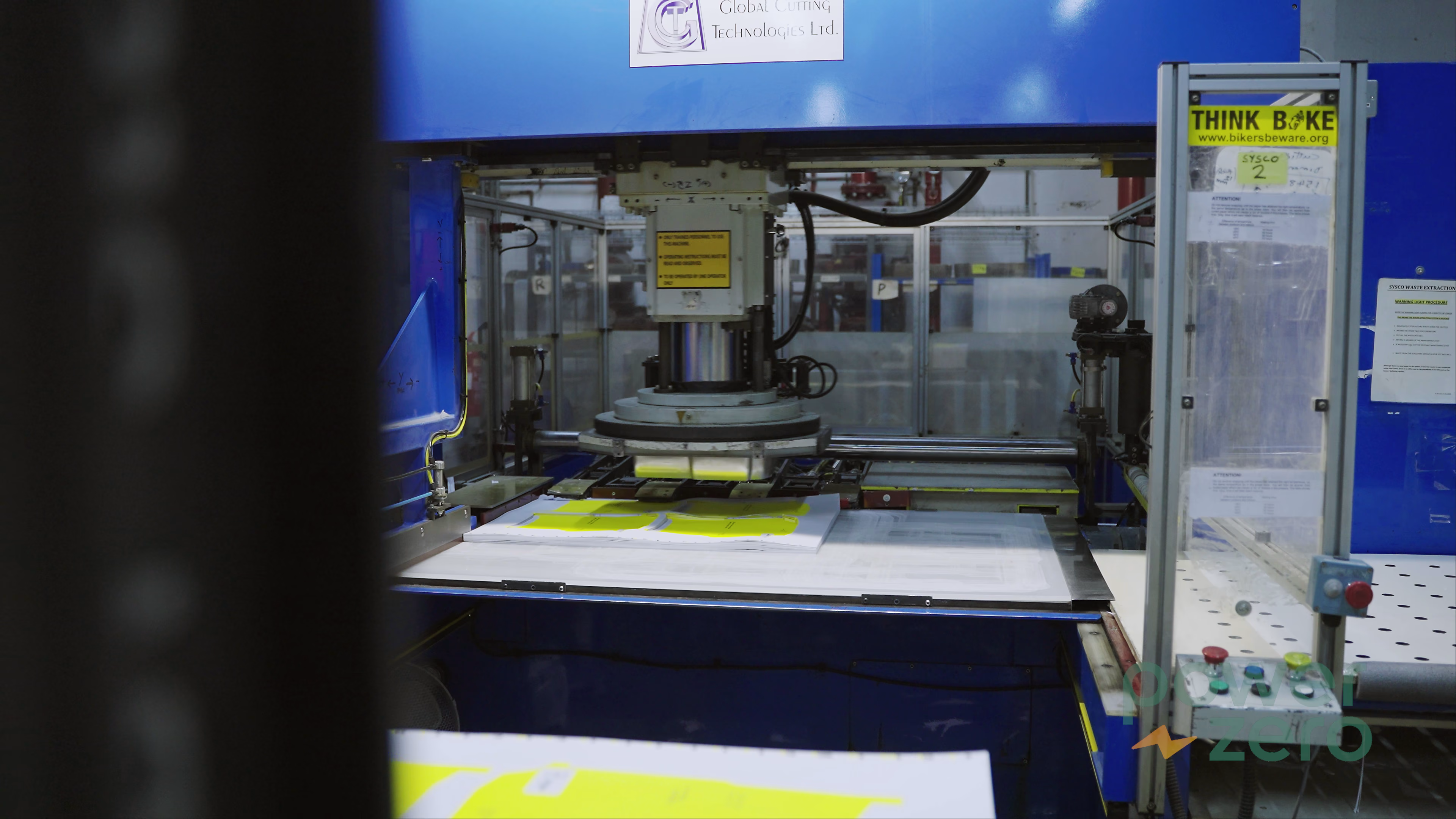 Printed material moving through specialist manufacturing equipment