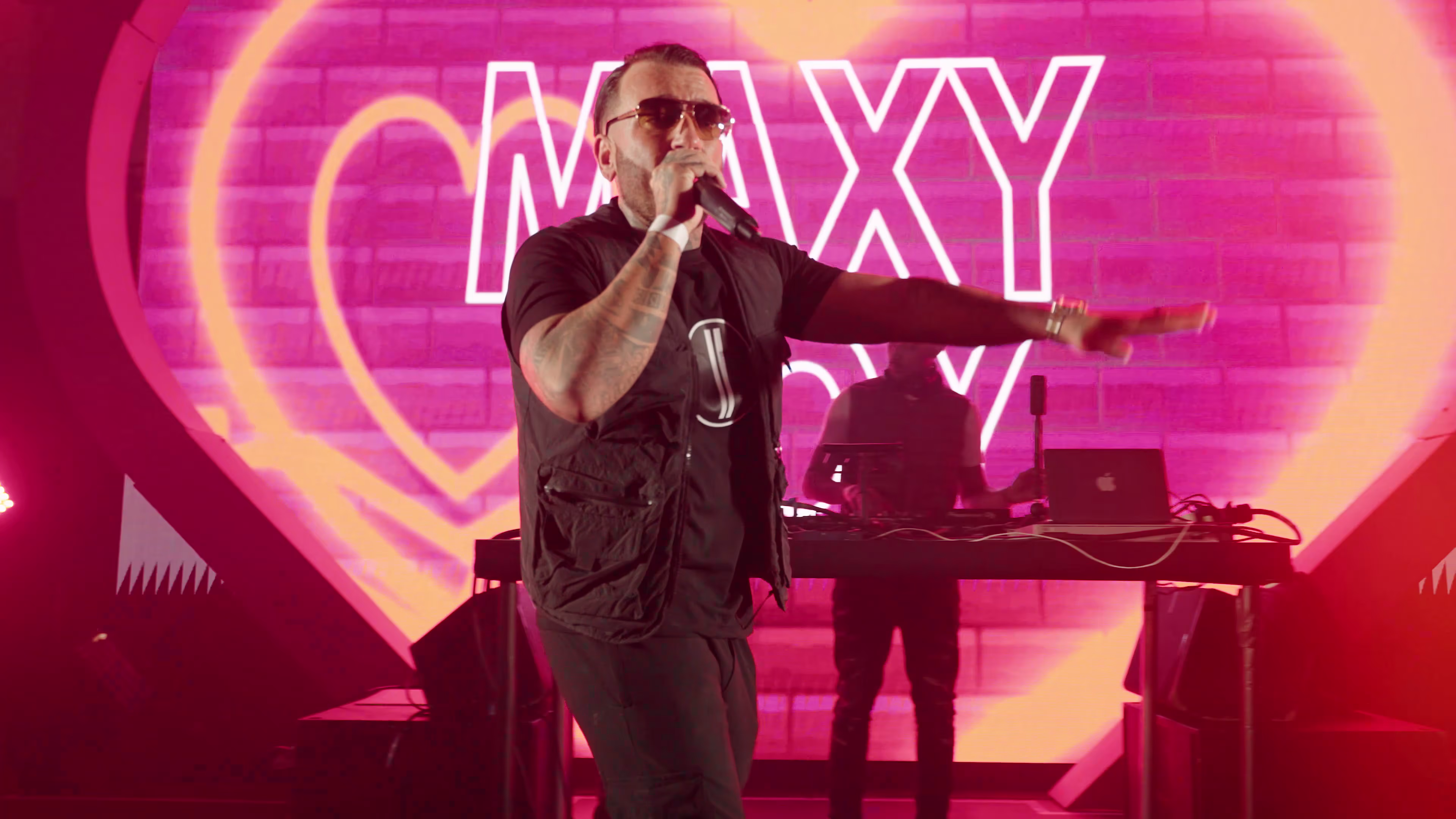 Maxy Boy performing against the event screen graphics