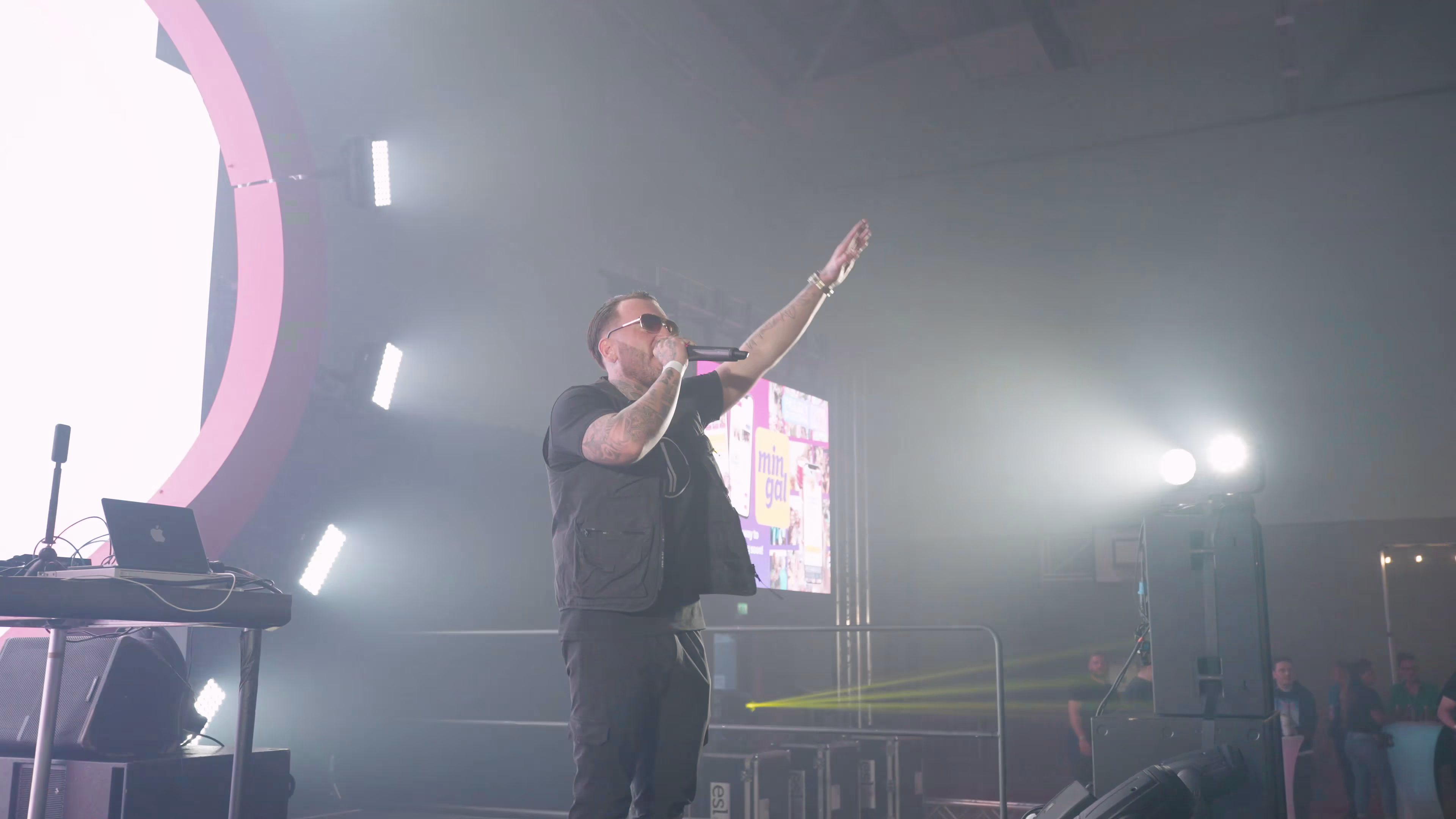 One videographer filming Maxy Boy from a wide stage angle at Show Me Love