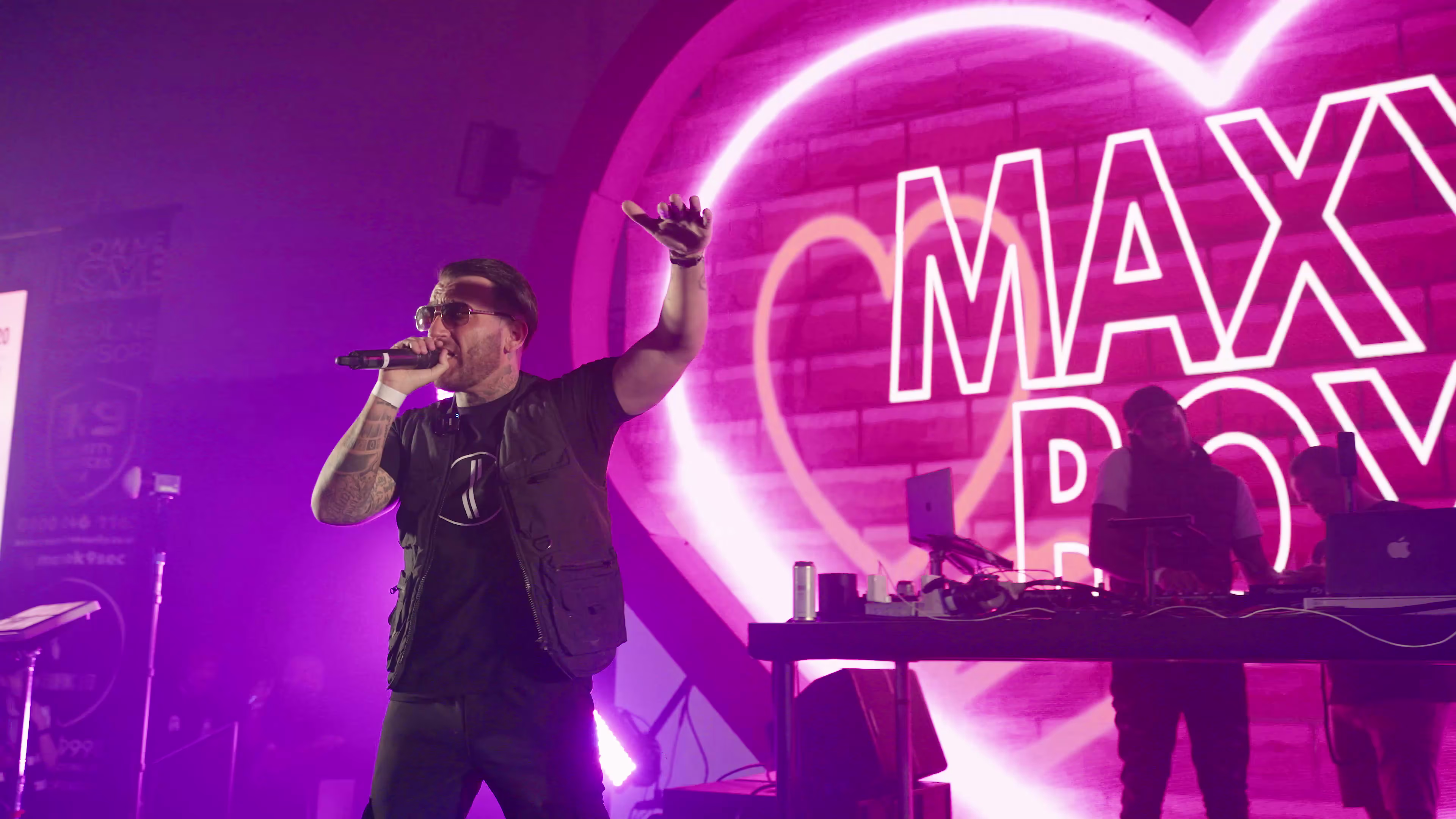 Maxy Boy raising his hand during the live performance