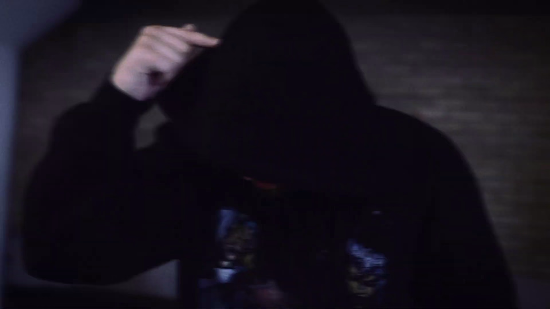 New Guardz performer lowering his hood during the music video
