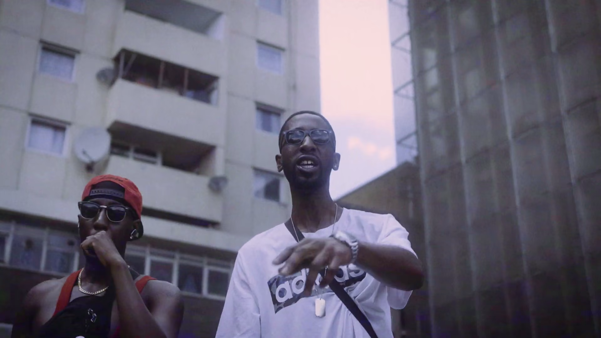 Two New Guardz members performing outside a residential block