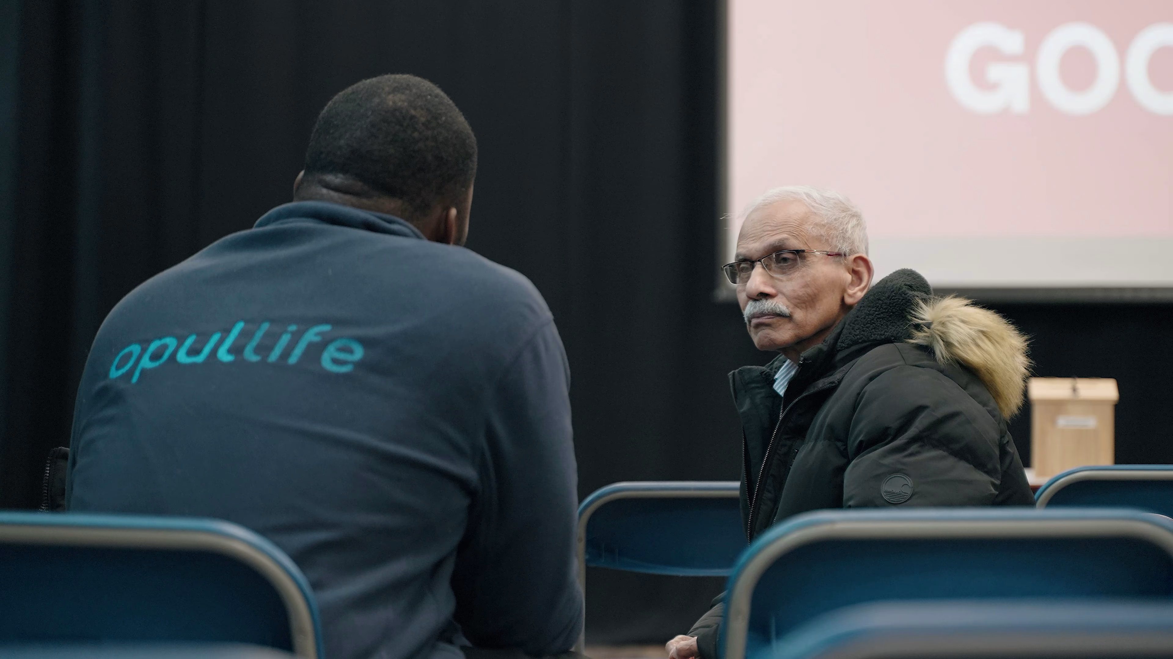 Branded Opul Life team member listening during an Essex outreach visit