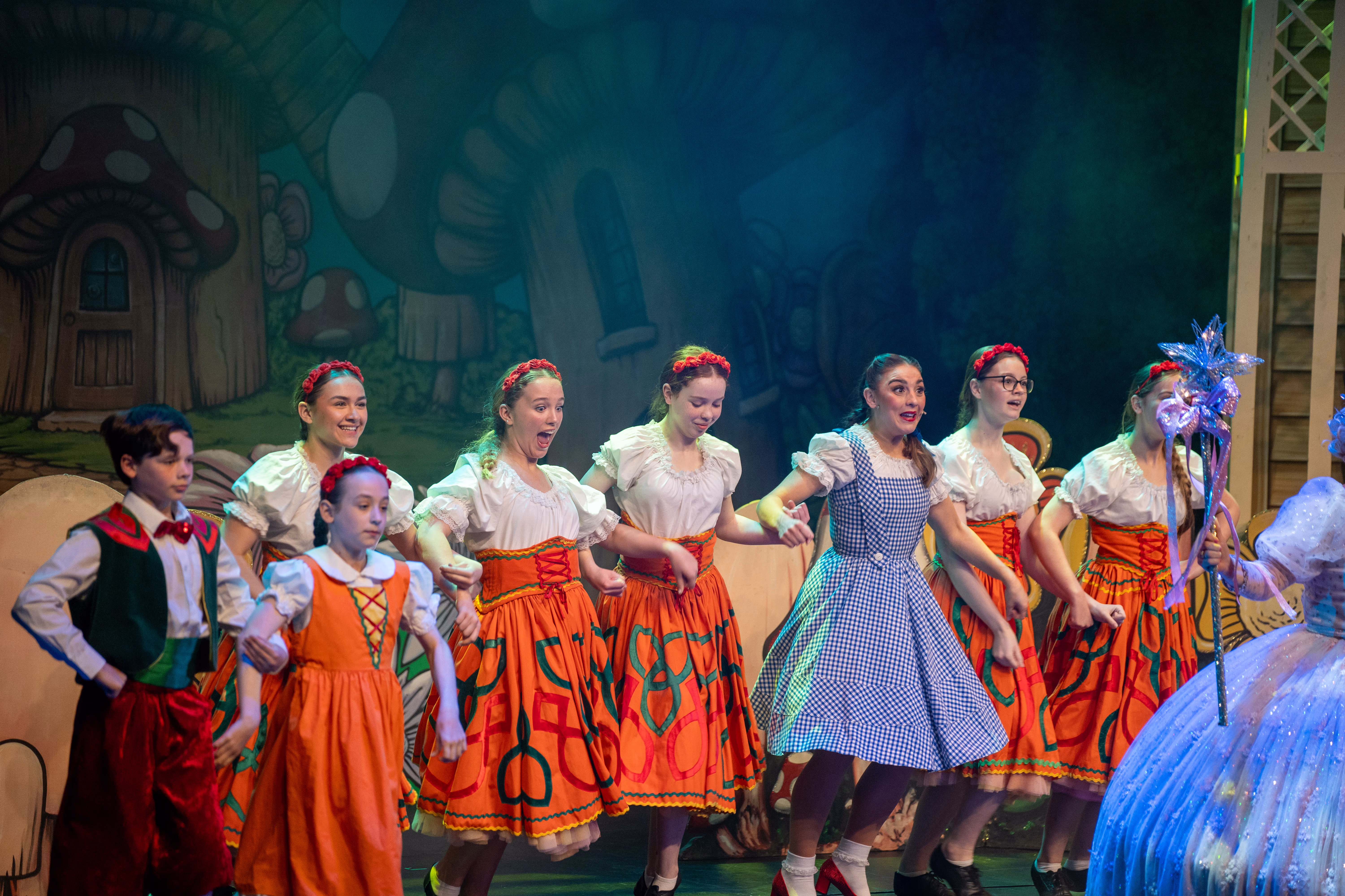 Dorothy and dancers performing a colourful ensemble number