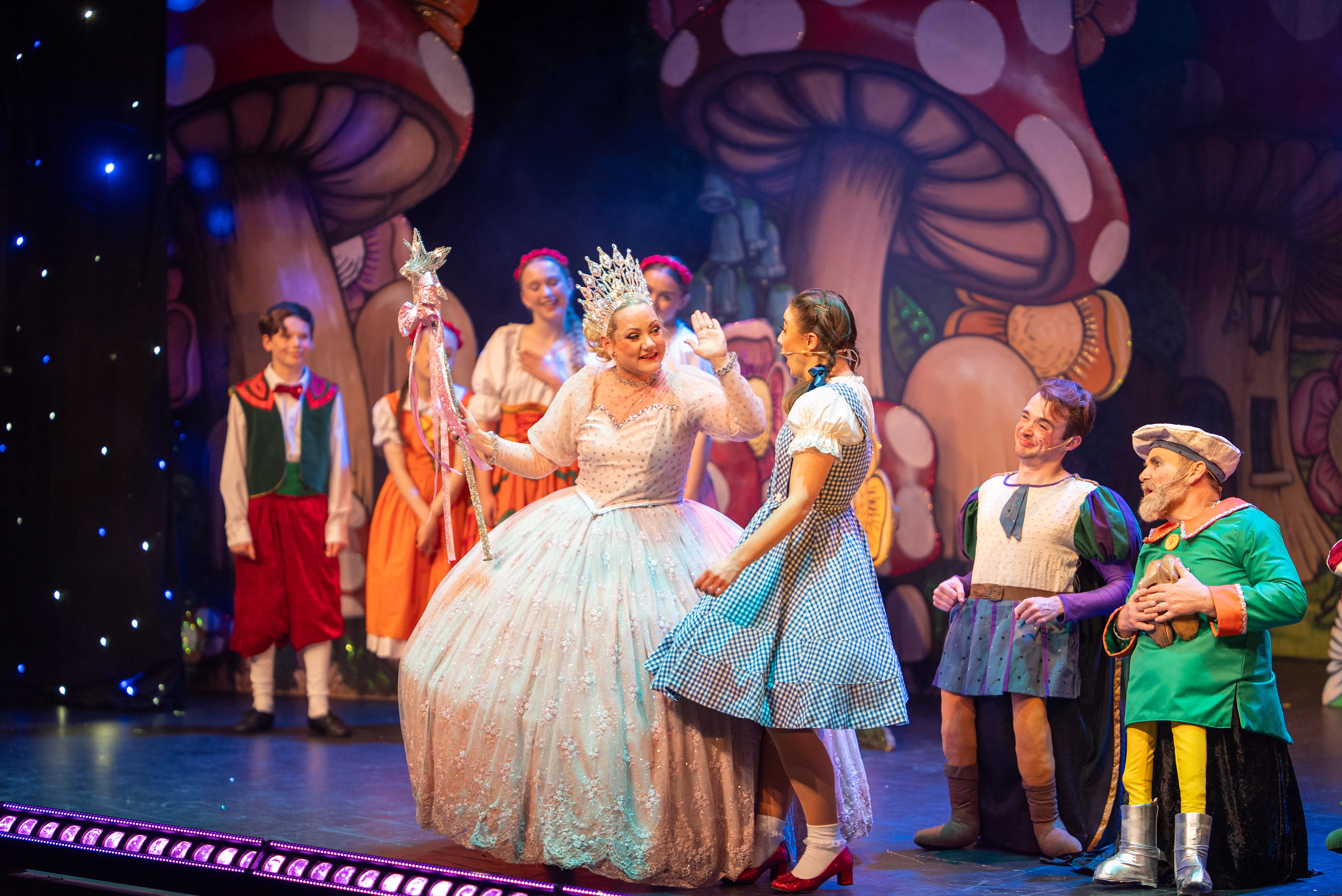Glinda, Dorothy and the ensemble in Polkadot Pantomimes' The Wizard of Oz