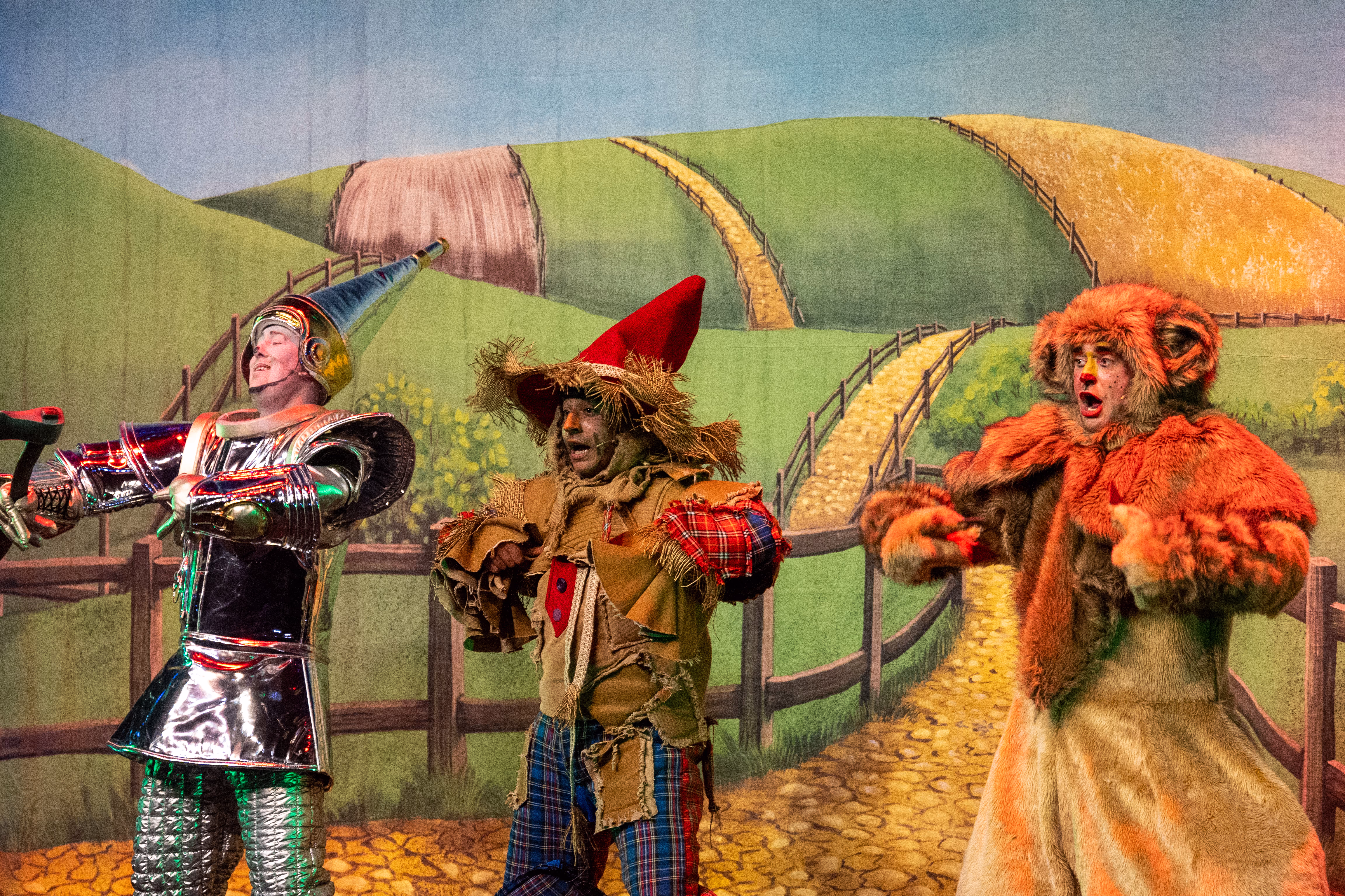 The Tin Man, Scarecrow and Cowardly Lion performing together