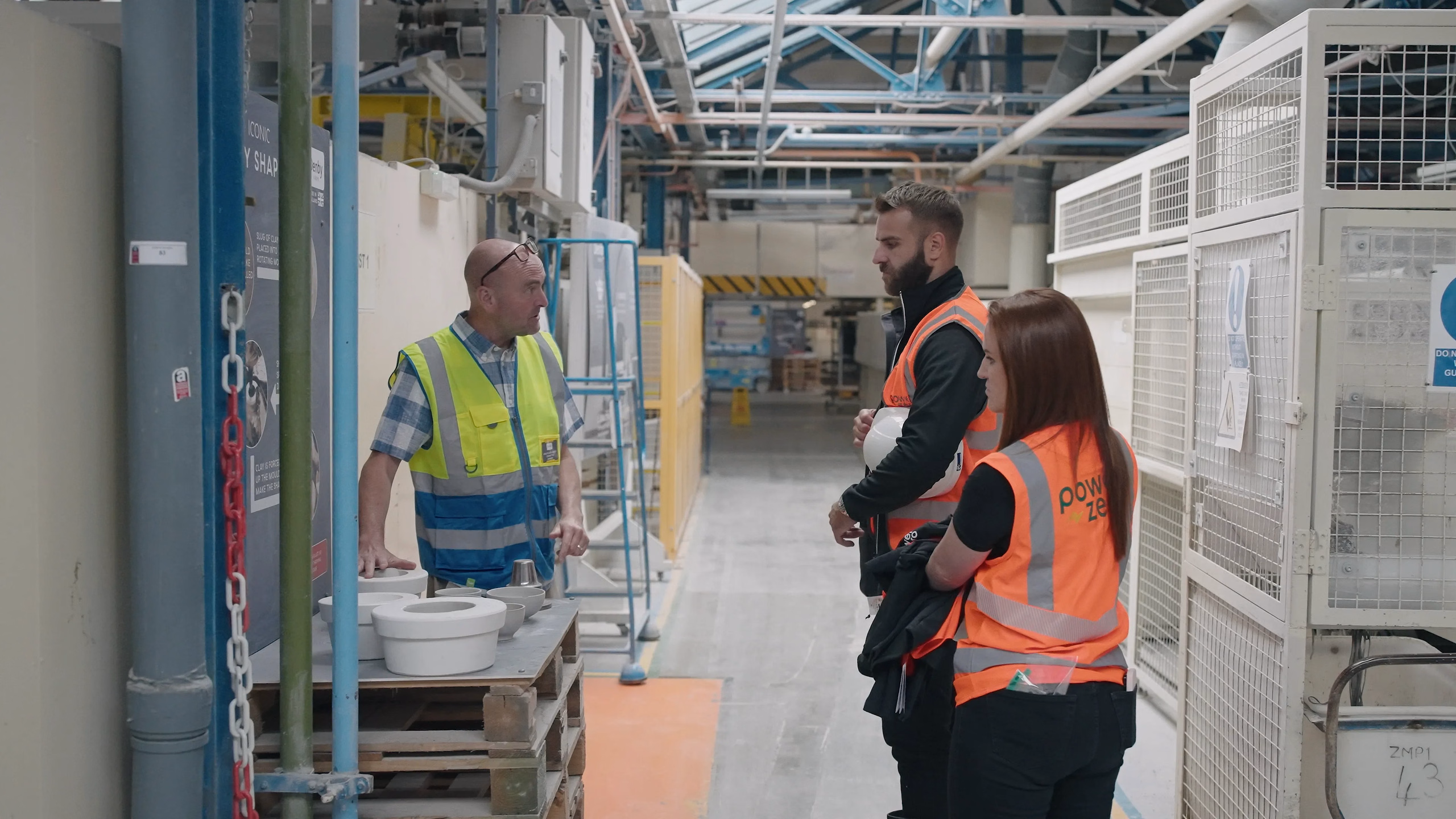 Power-Zero and Denby Pottery representatives discussing the production line