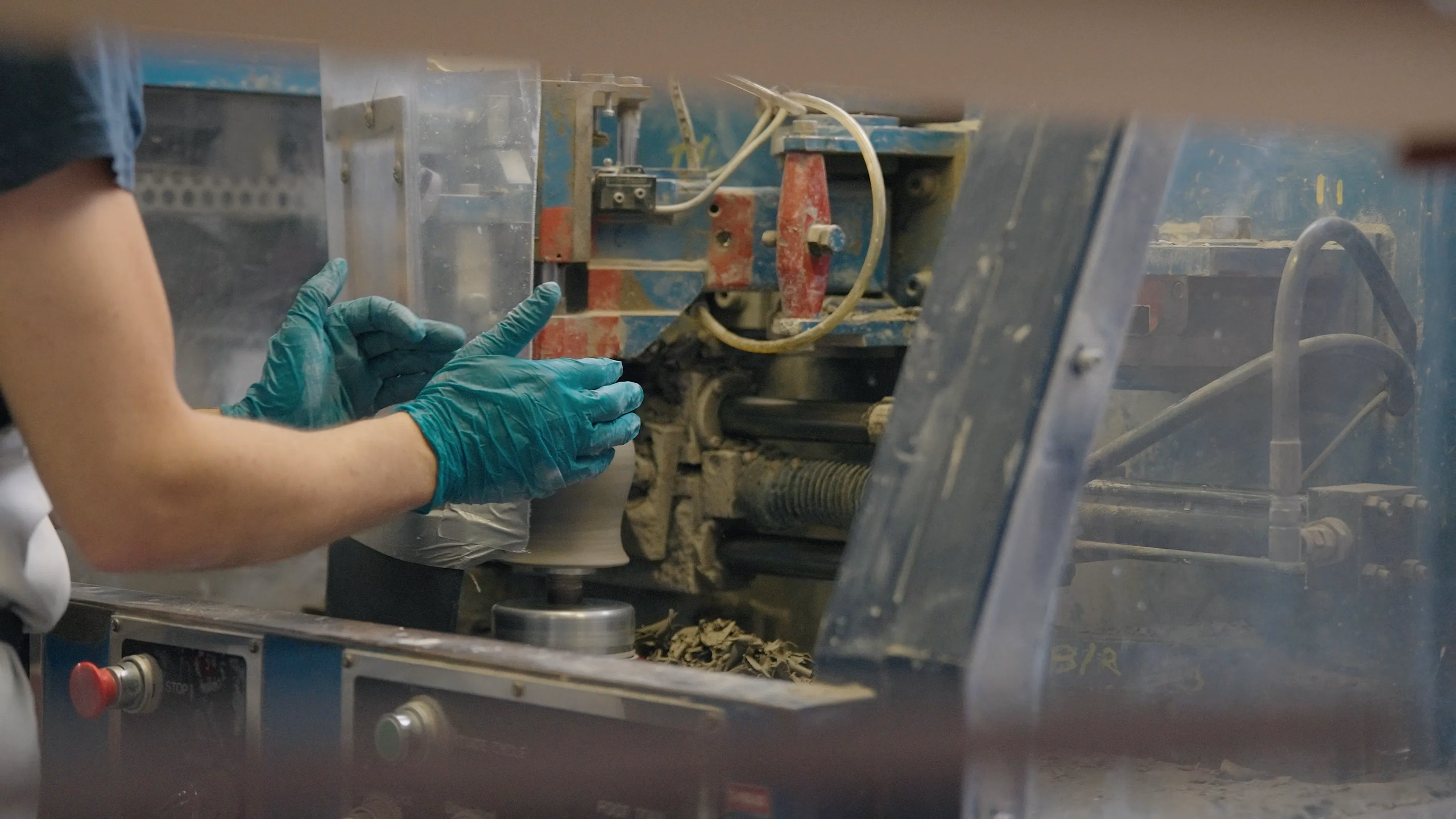 A Denby craftsperson working on the glazing process