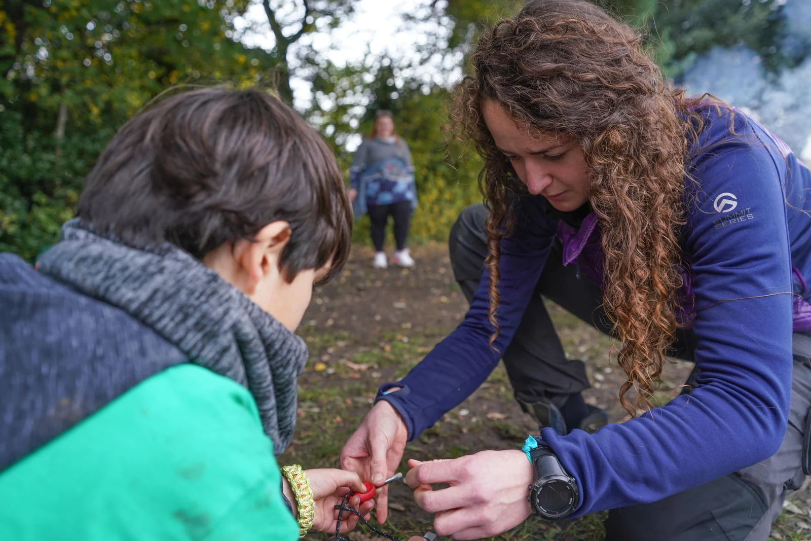 Hive instructor demonstrating an outdoor activity to children